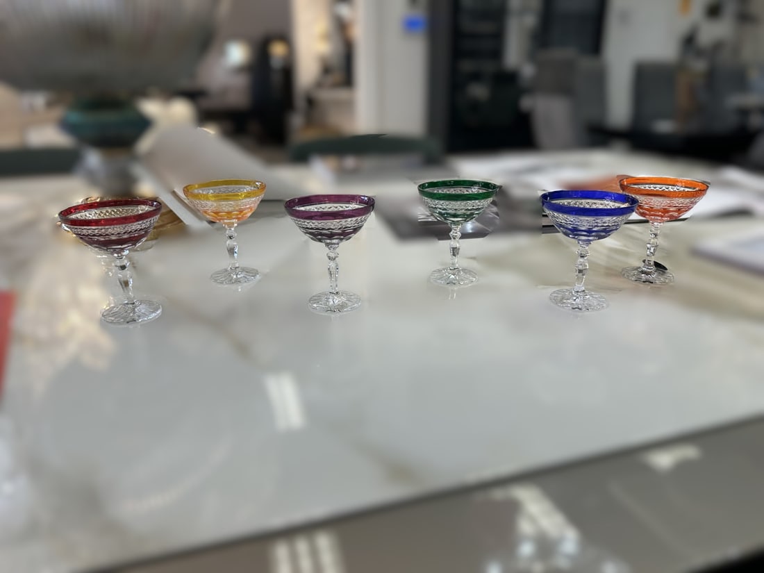 Polish Crystal Glassware: A vibrant expression of European craftsmanship, this Polish crystal glassware set features intricately cut crystal accented with rich jewel-toned hues. Combining timeless elegance with striking color,