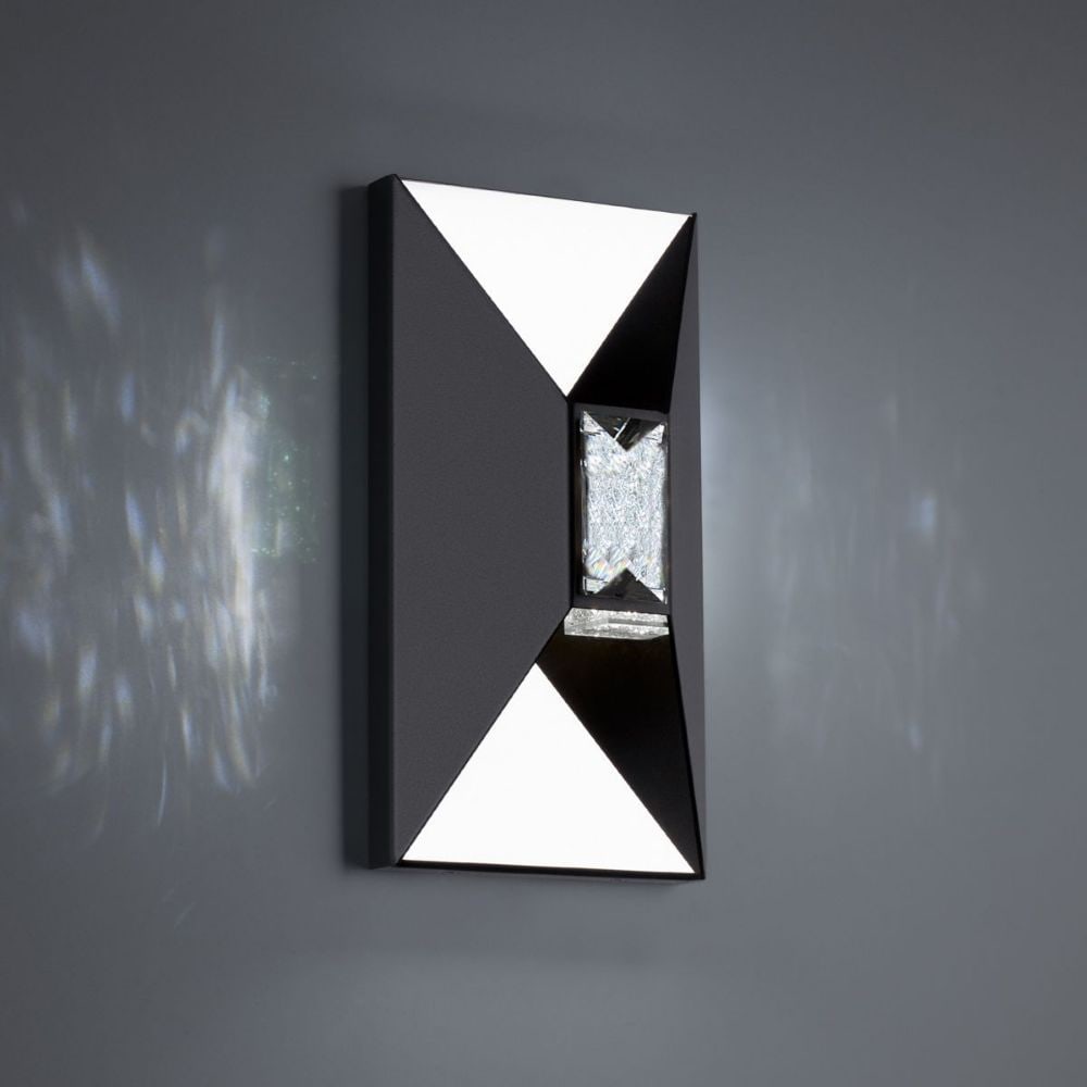 Vida 12'' Outdoor Wall Sconce in Black: The Vida Wall Sconce has an angular design that is complimented by faceted crystals that provide a dimensional design. You will lose yourself from the illuminations of the reflections depths. Made by 