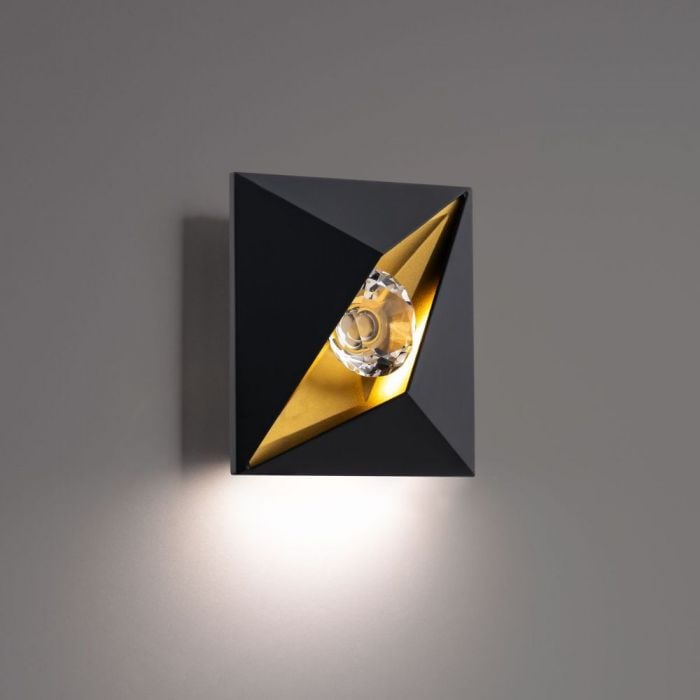 Schonbek Beyond Mythical Wall Sconce: The Mythical Wall Sconce simulates an all-seeing eye using a faceted crystal gem contained within a sleek triangular frame, emanating its divine rays of sparkling light. Suitable for both outdoor and 