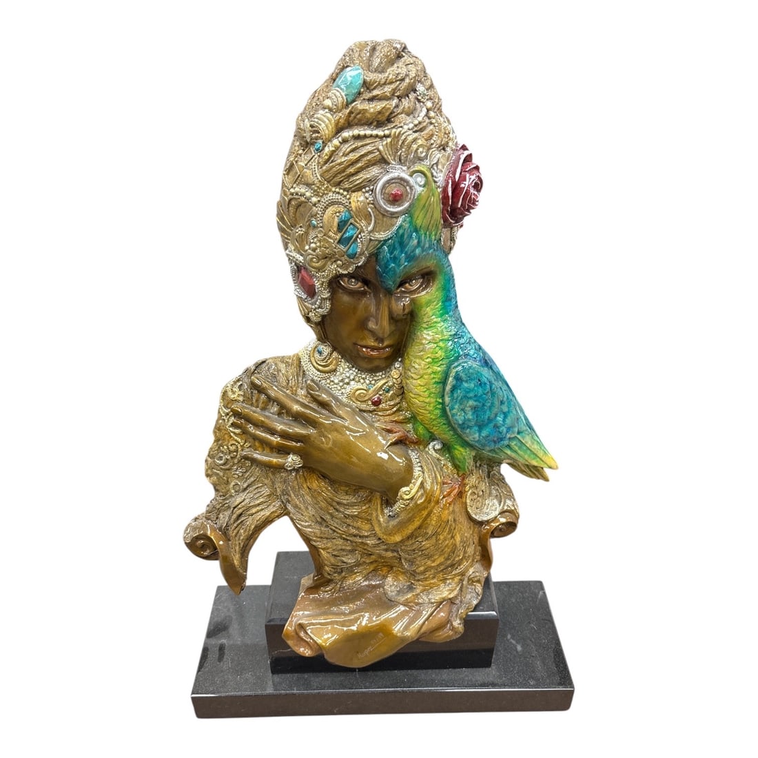 Ari Harpaz "Queen Esther " Bronze sculpture: An exquisite, highly detailed polychrome bronze bust depicting a majestic female figure adorned in elaborate, jewel-encrusted headdress and jewelry. A vibrantly enameled turquoise and green parrot res