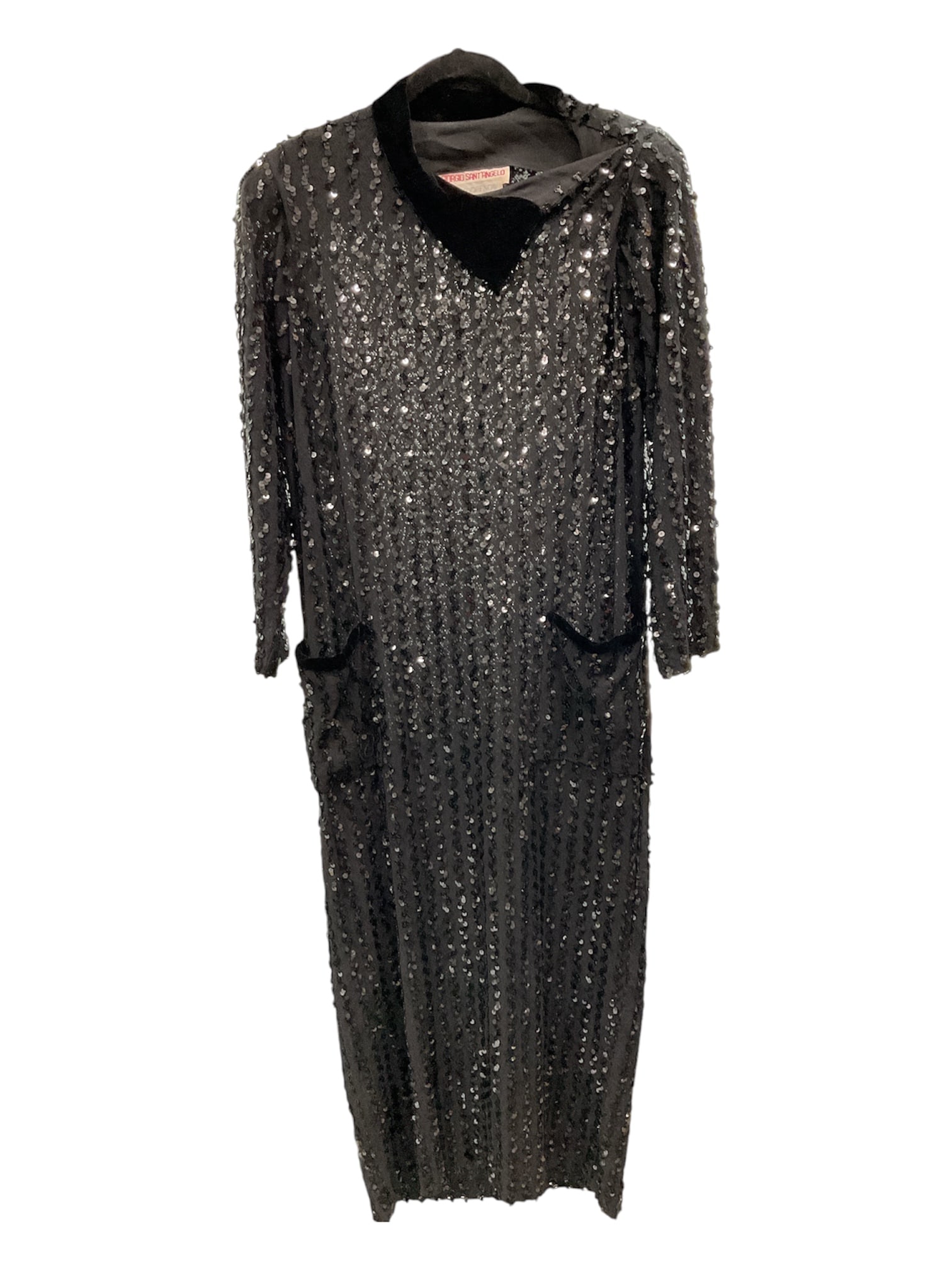 Giorgio Sant'Angelo (Italian-American, 1933-1989) Sequined Evening Dress: This sophisticated full-length evening gown by Giorgio Sant'Angelo is a masterclass in high-glamour minimalism. The garment is entirely encrusted with shimmering black sequins, featuring a sleevel