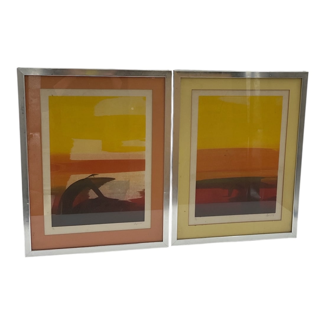 Pair of Abstract Modernist Color Field Prints: Pair of abstract modernist prints featuring layered bands of warm yellow, orange, and earth-tone hues in minimalist compositions. Presented under glass with matting in matching metallic frames. Decora