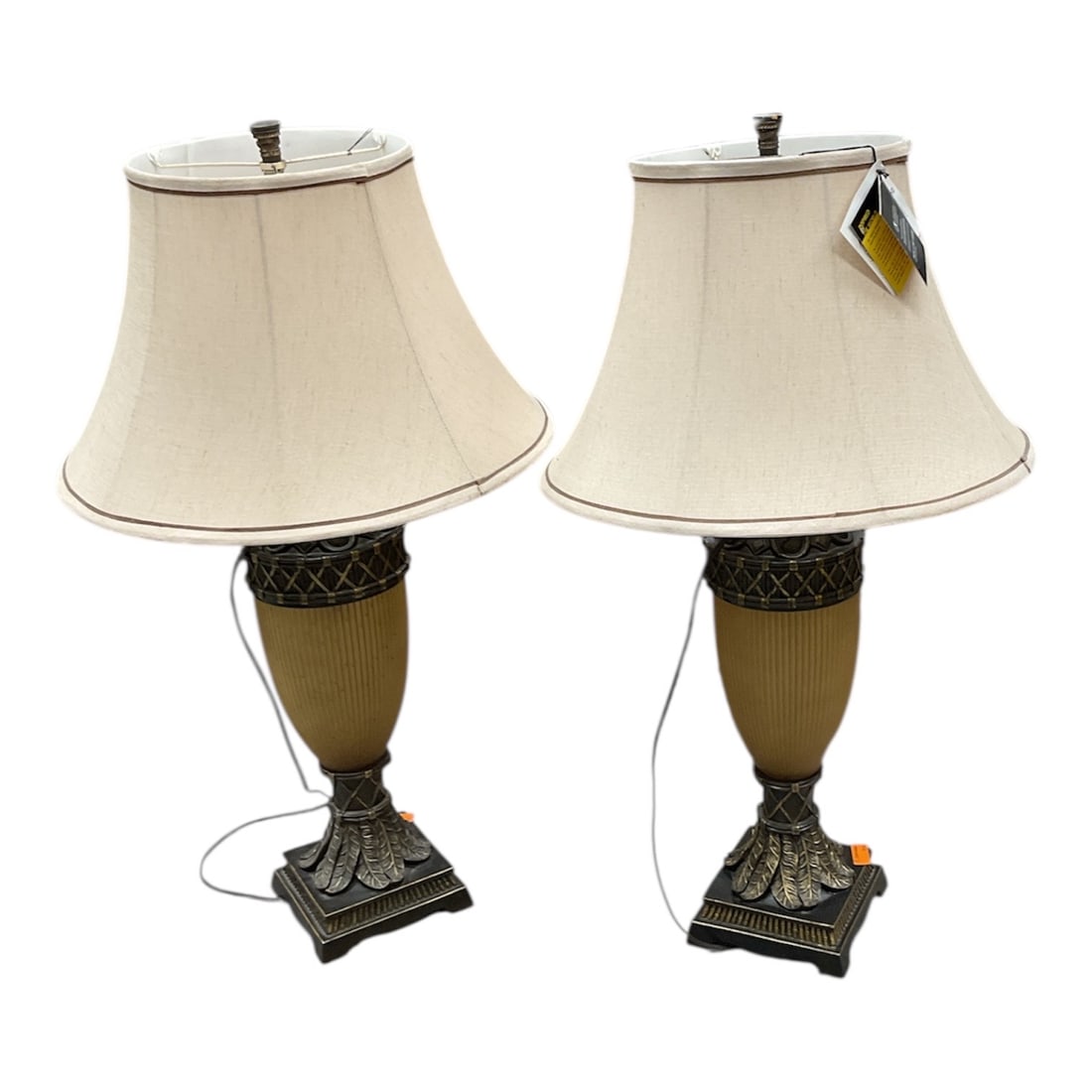 Pair of National Geographic Home Collection Table Lamps, 2008: Pair of National Geographic Home Collection table lamps manufactured by Pacific Coast Lighting, dated 2008. Each lamp features a decorative base with a textured, antiqued finish, combining classical a