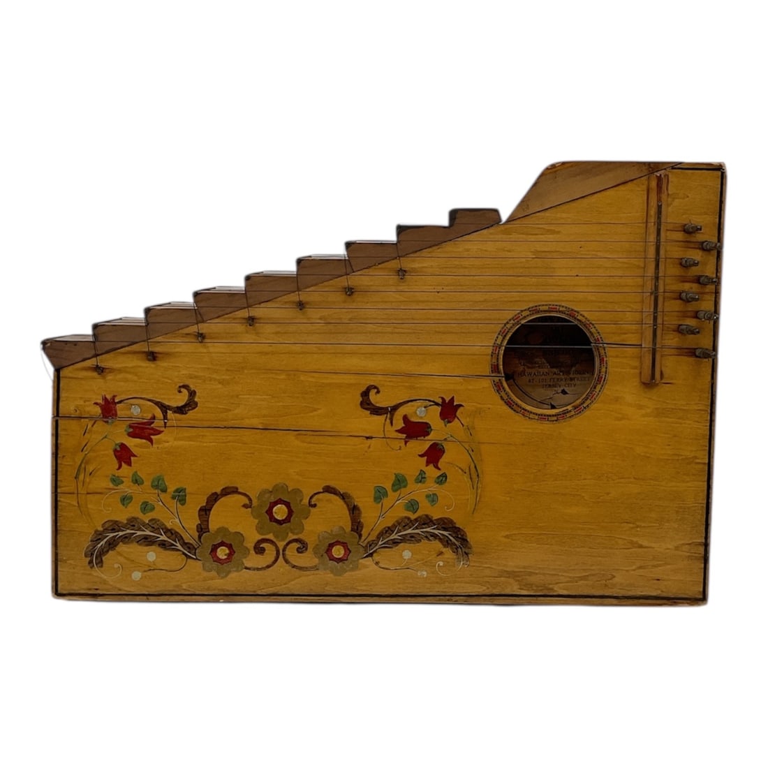 Hawaiian Art Wooden Zither String Instrument 61-10 Ferry Street Newark NJ: Vintage wooden string instrument in a zither form, featuring multiple strings stretched across a stepped body with decorative floral accents. The instrument retains an interior label reading Hawaiian 