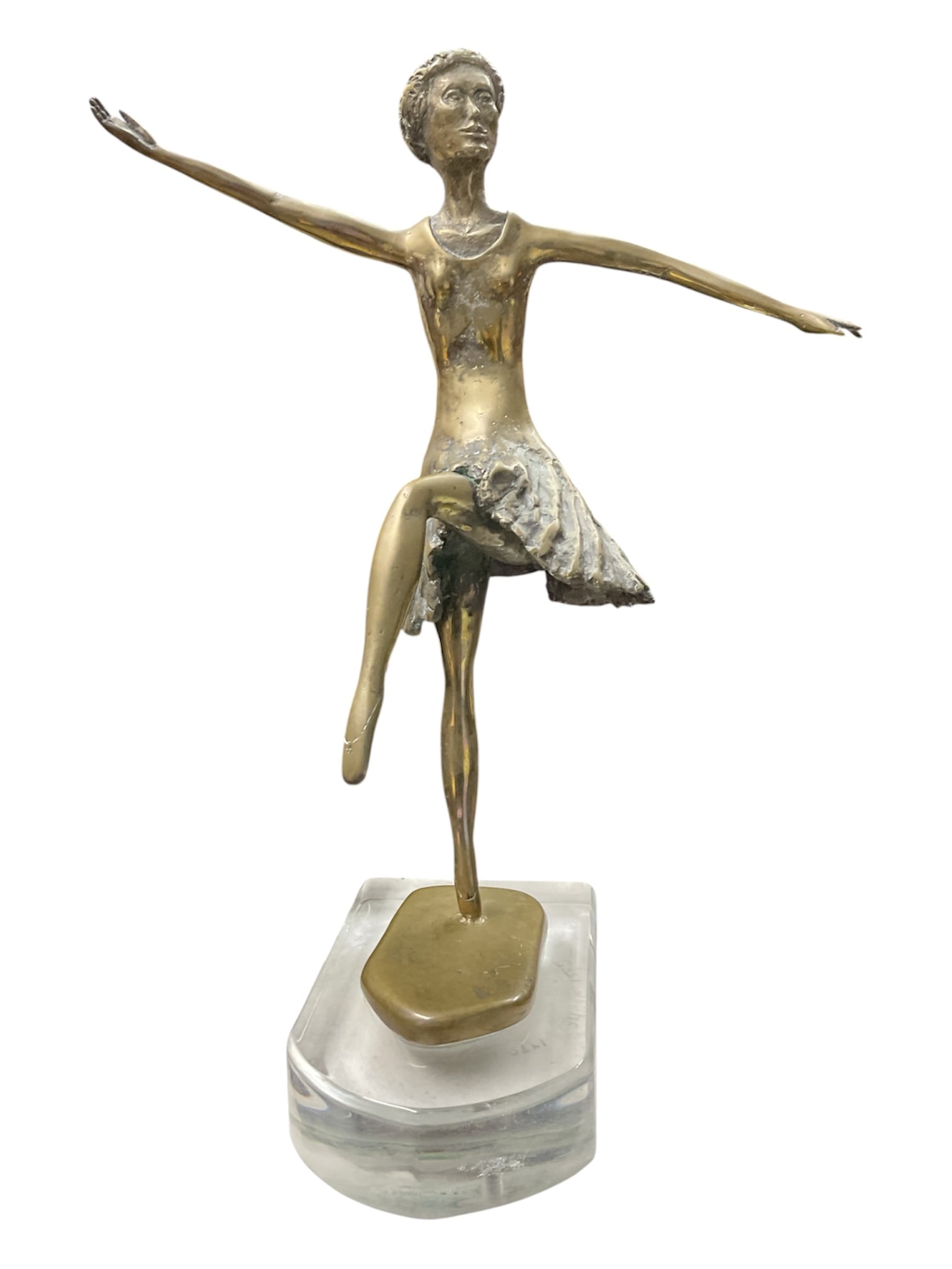 B. Chaikin Bronze Figural Ballerina Sculpture on Lucite Base: Elegant modernist figural sculpture depicting a ballerina in mid-dance pose with extended arms and raised leg. Cast in bronze-tone metal with textured skirt detailing and mounted on a clear Lucite bas