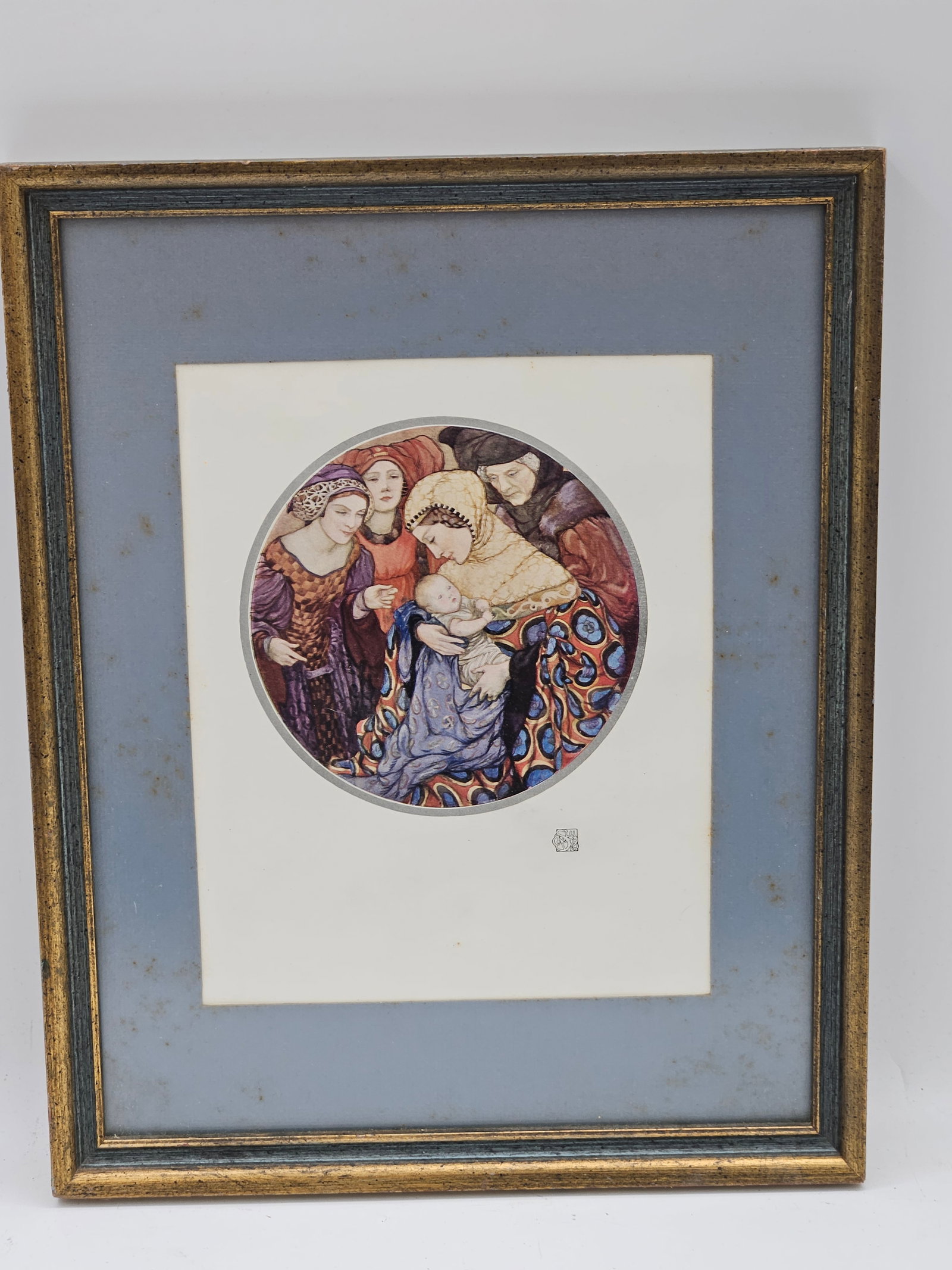 Framed Circular Art Print of Women in Embrace: A framed circular art print depicting a group of women in richly patterned robes, gathered in an emotional and protective embrace. The style suggests inspiration from early 20th-century Art Nouveau