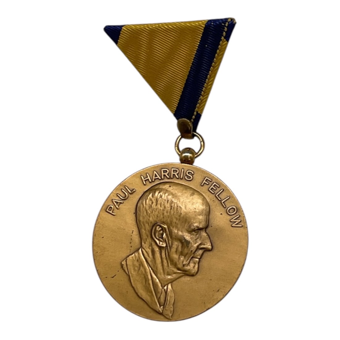 Paul Harris Fellow Rotary International Medal: Commemorative Paul Harris Fellow medal featuring a profile portrait of Rotary International founder Paul Harris with engraved lettering. Suspended from a blue and gold ribbon, this medal was awarded