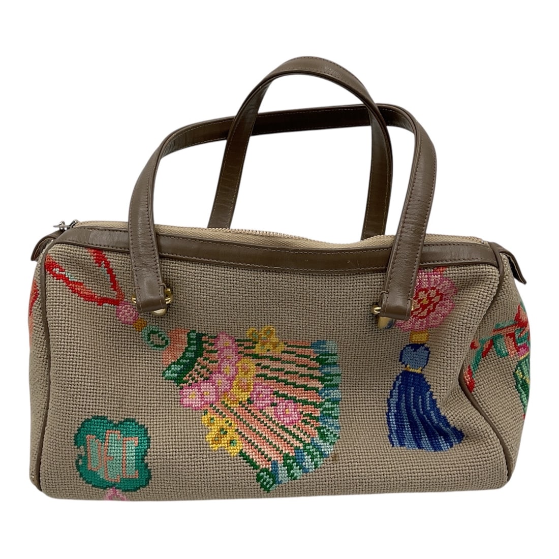 Vintage Needlepoint Handbag by Meisel Fischer: Vintage handbag featuring hand-stitched needlepoint decoration with colorful floral and figural motifs on a neutral woven ground. Includes dual brown handles, zip-top closure, and interior label