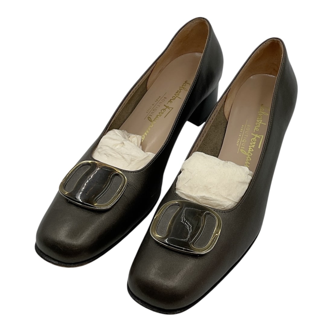 Salvatore Ferragamo Brown Leather Pumps Size 7.5: Pair of Salvatore Ferragamo women’s pumps crafted in brown leather featuring square toes and oversized tonal buckle accents across the vamps. Classic low heel silhouette with refined Italian