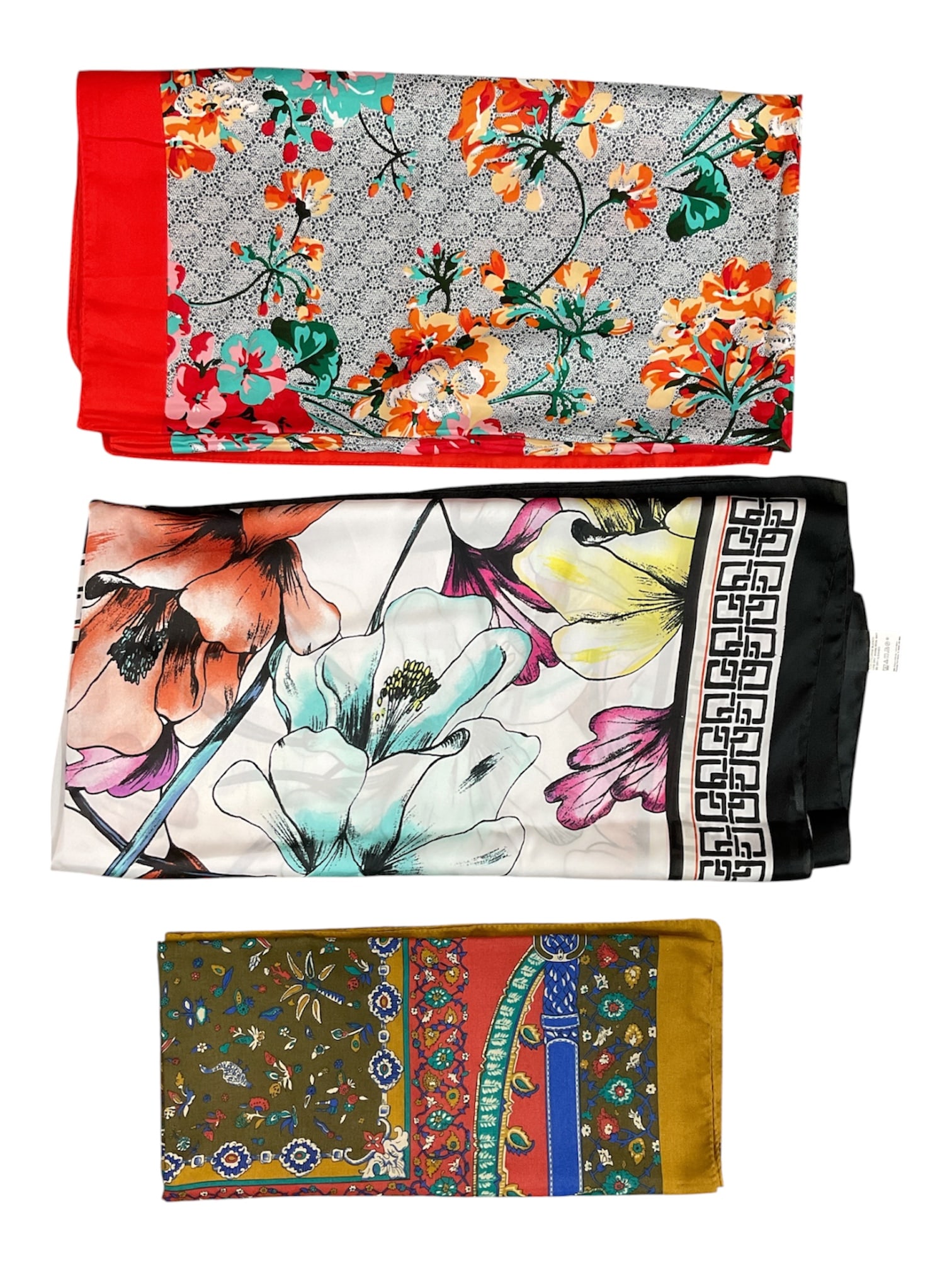 Group of Three Vintage Floral and Decorative Fashion Scarves: Collection of three vintage fashion scarves featuring colorful floral and decorative motifs. Includes a vibrant red-bordered floral scarf, a large floral example with Greek key border decoration, and