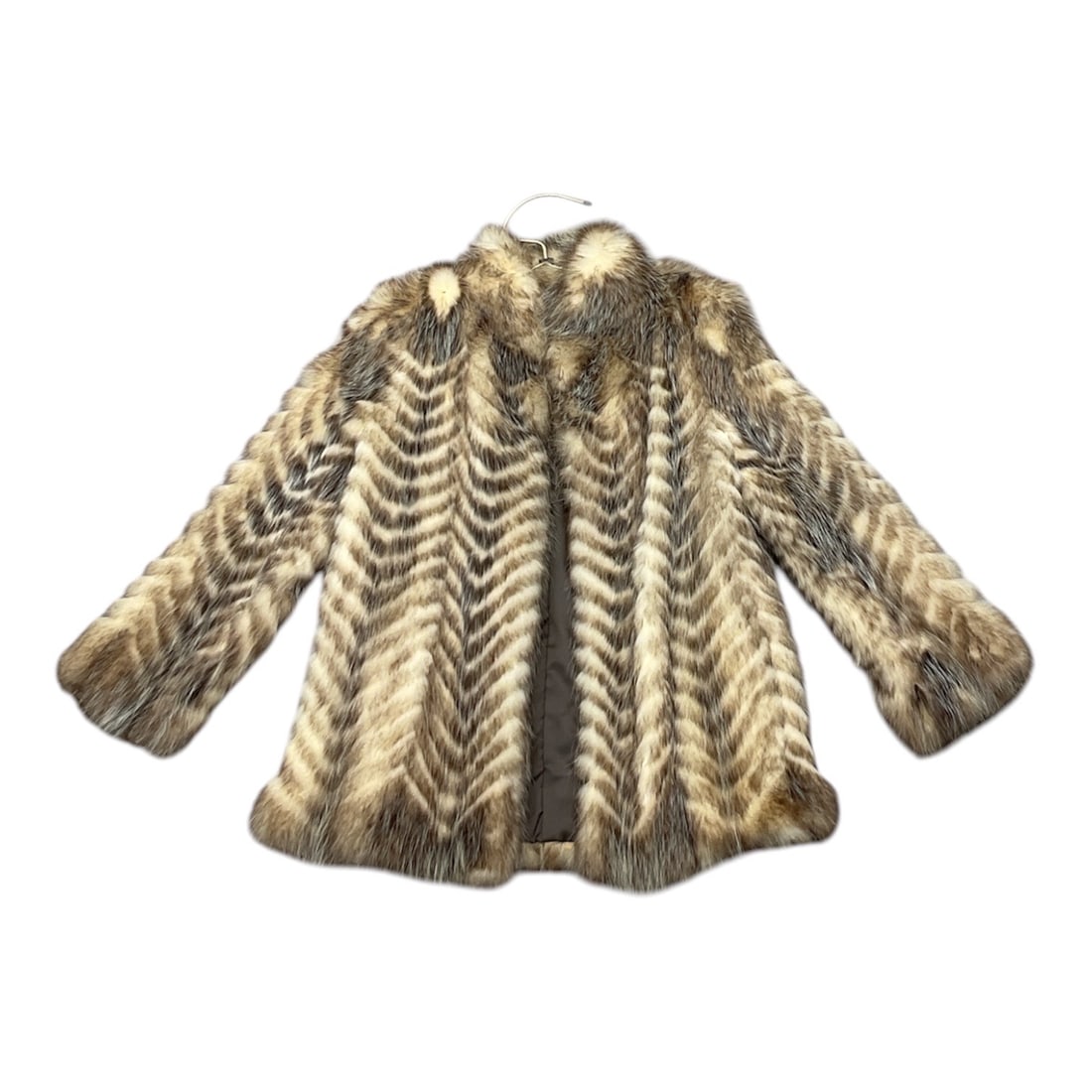 Vintage Chevron Fur Coat: Vintage 1970s fur coat featuring a striking chevron-patterned design, likely crafted from raccoon or opossum fur. The dramatic silhouette includes balloon sleeves and a large structured shawl collar,