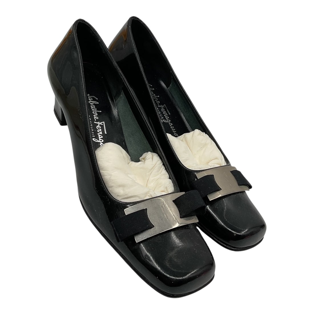 Salvatore Ferragamo Black Patent Leather Pumps Size 7.5: Pair of Salvatore Ferragamo women’s pumps crafted in black patent leather featuring square toes with signature bow and silver-tone logo hardware accents across the vamps. Elegant low heel