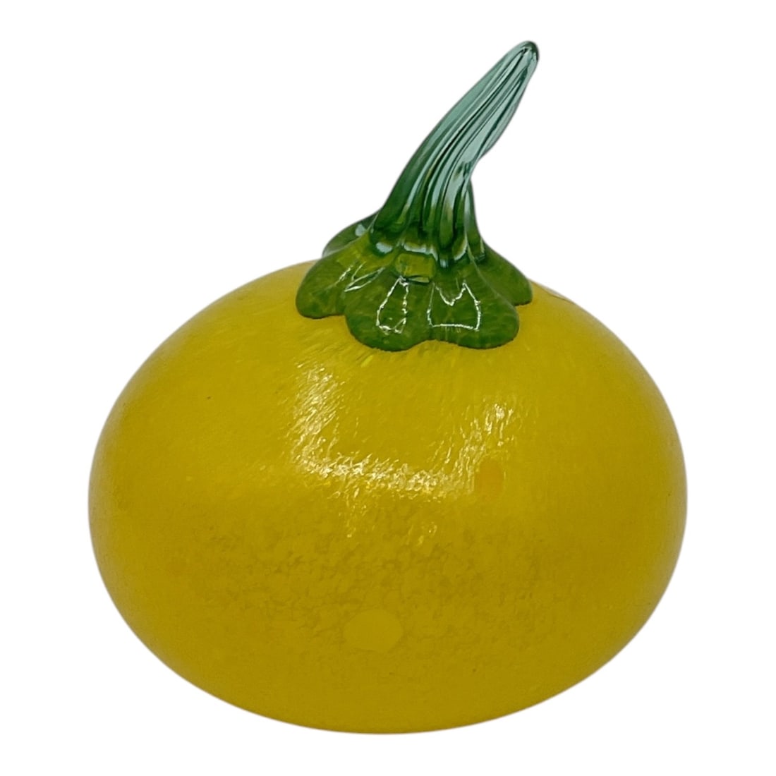 Yellow Art Glass Fruit Form Paperweight: Decorative art glass sculpture in the form of a yellow citrus fruit with textured surface and green stem detail. Realistically modeled with vibrant coloration and glossy finish. Attractive decorative