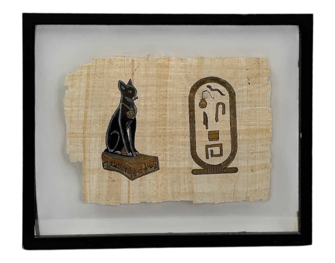 Handmade Egyptian Papyrus Artwork Featuring Bastet and Cartouche: Handmade Egyptian papyrus art piece depicting the goddess Bastet rendered as a seated black cat alongside a stylized cartouche motif. Executed on natural papyrus with traditional Egyptian-inspired