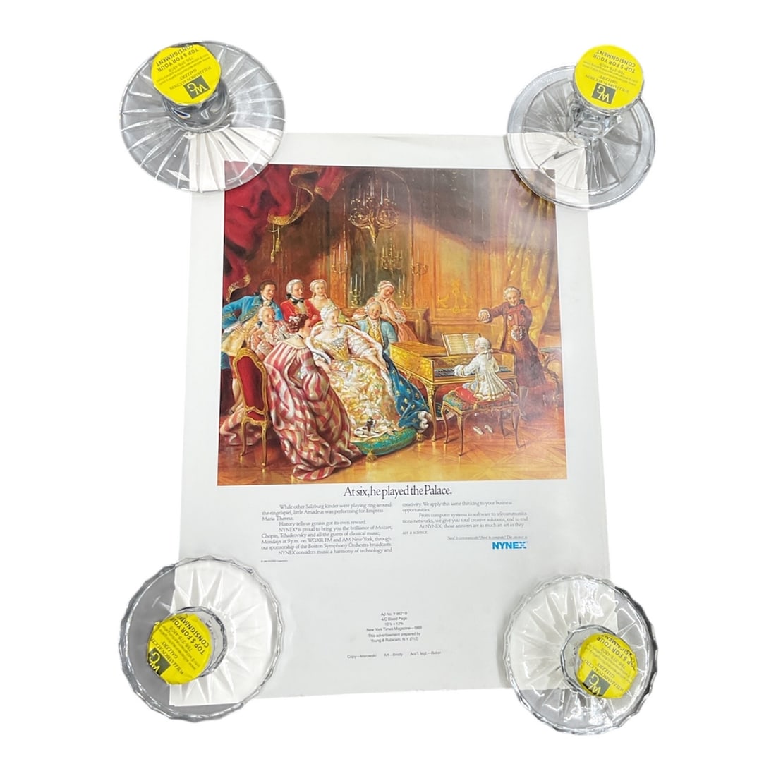 NYNEX, At Six, He Played the Palace, Mozart Advertisement Poster, 1989: Vintage advertising poster featuring a classical scene of a young Mozart performing before European aristocracy, accompanied by the headline “At six, he played the Palace.” Produced for NY