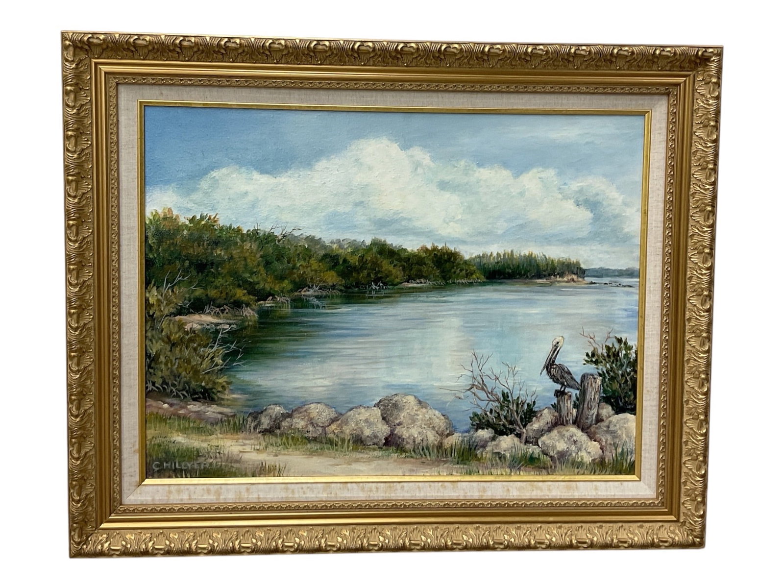 Coastal Landscape Painting Signed Chillyer: A decorative coastal landscape painting depicting a tranquil shoreline with calm water, rocky foreground, and lush vegetation beneath a bright sky filled with soft clouds. The composition is rendered