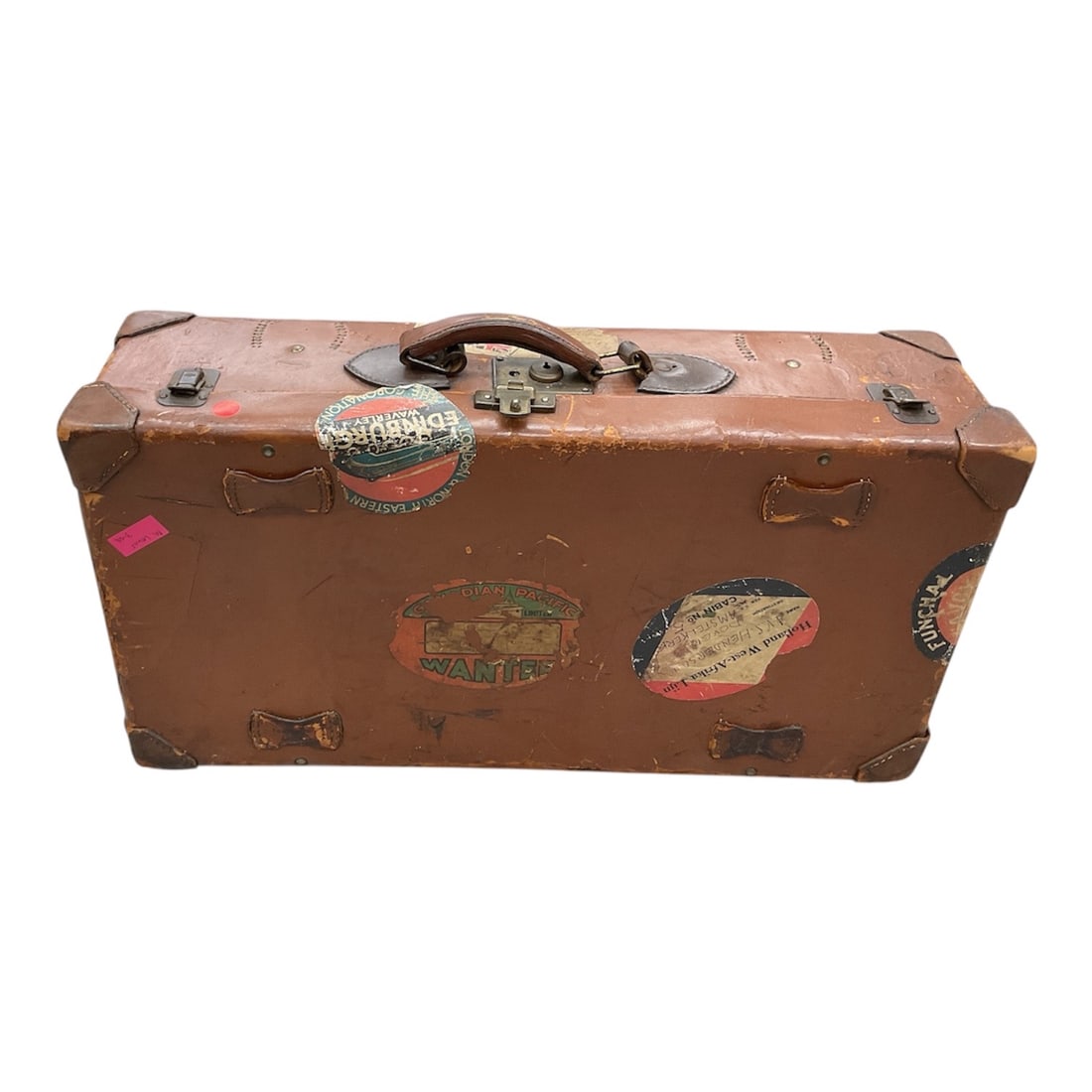 Gemini said Antique Leather Travel Suitcase with Steamship Decals (American, Early 20th Century): A vintage brown leather suitcase featuring a rectangular form with reinforced stitched corners and a central leather carry handle. The exterior is adorned with several original weathered travel decals
