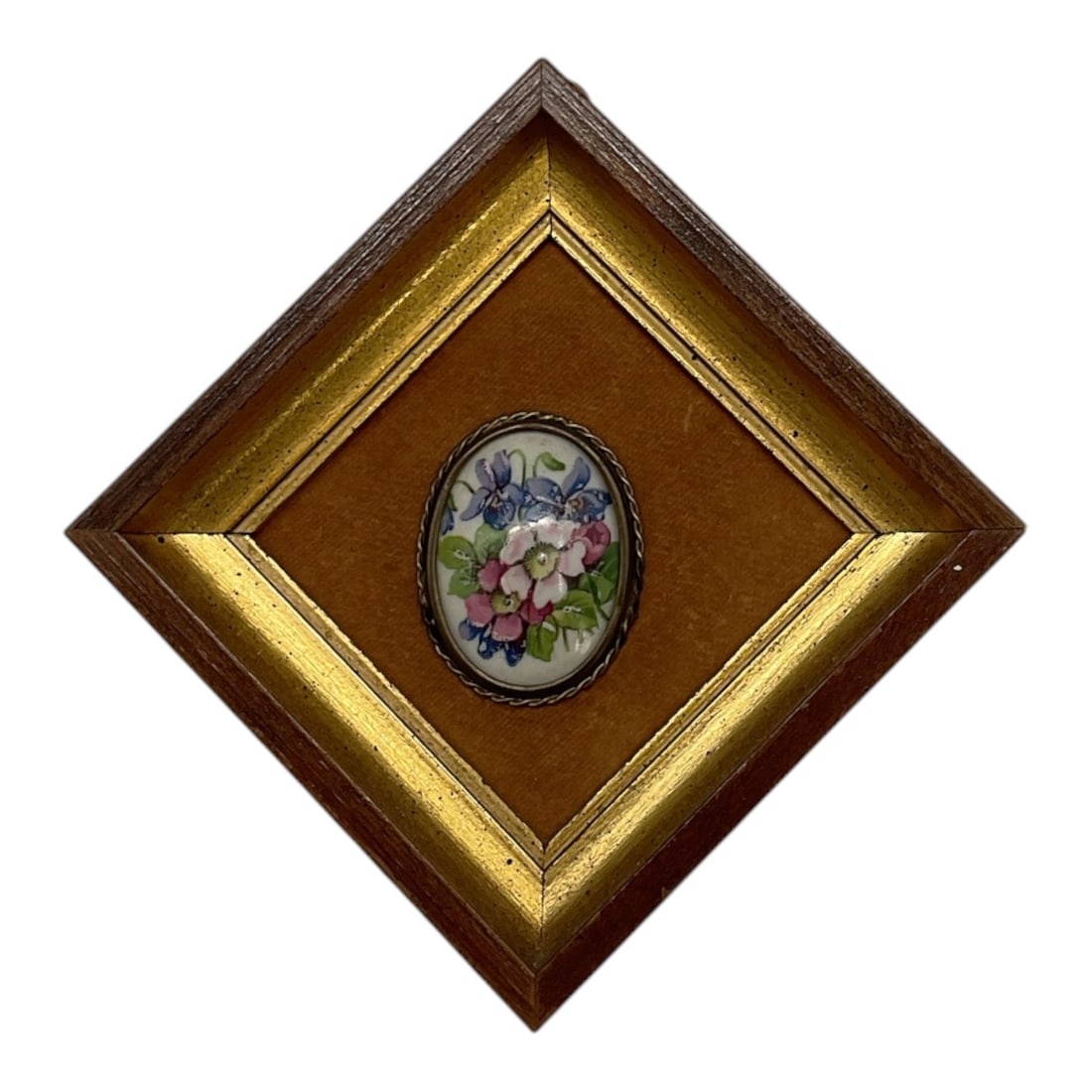Framed Floral Porcelain Plaque: A miniature framed porcelain plaque featuring a hand-painted floral bouquet in pink, blue, and green tones. The oval porcelain insert is mounted within a diamond-oriented frame with gilt-tone inner bo