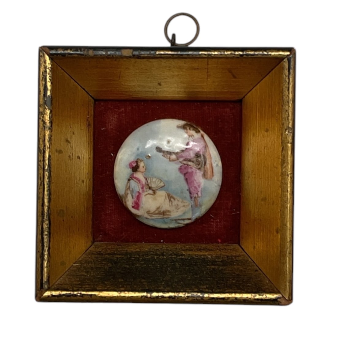 Framed Porcelain Miniature Plaque: A miniature porcelain plaque depicting an 18th-century style courting scene with elegantly dressed figures in a pastoral setting. The circular hand-painted plaque is mounted within a deep shadowbox-st