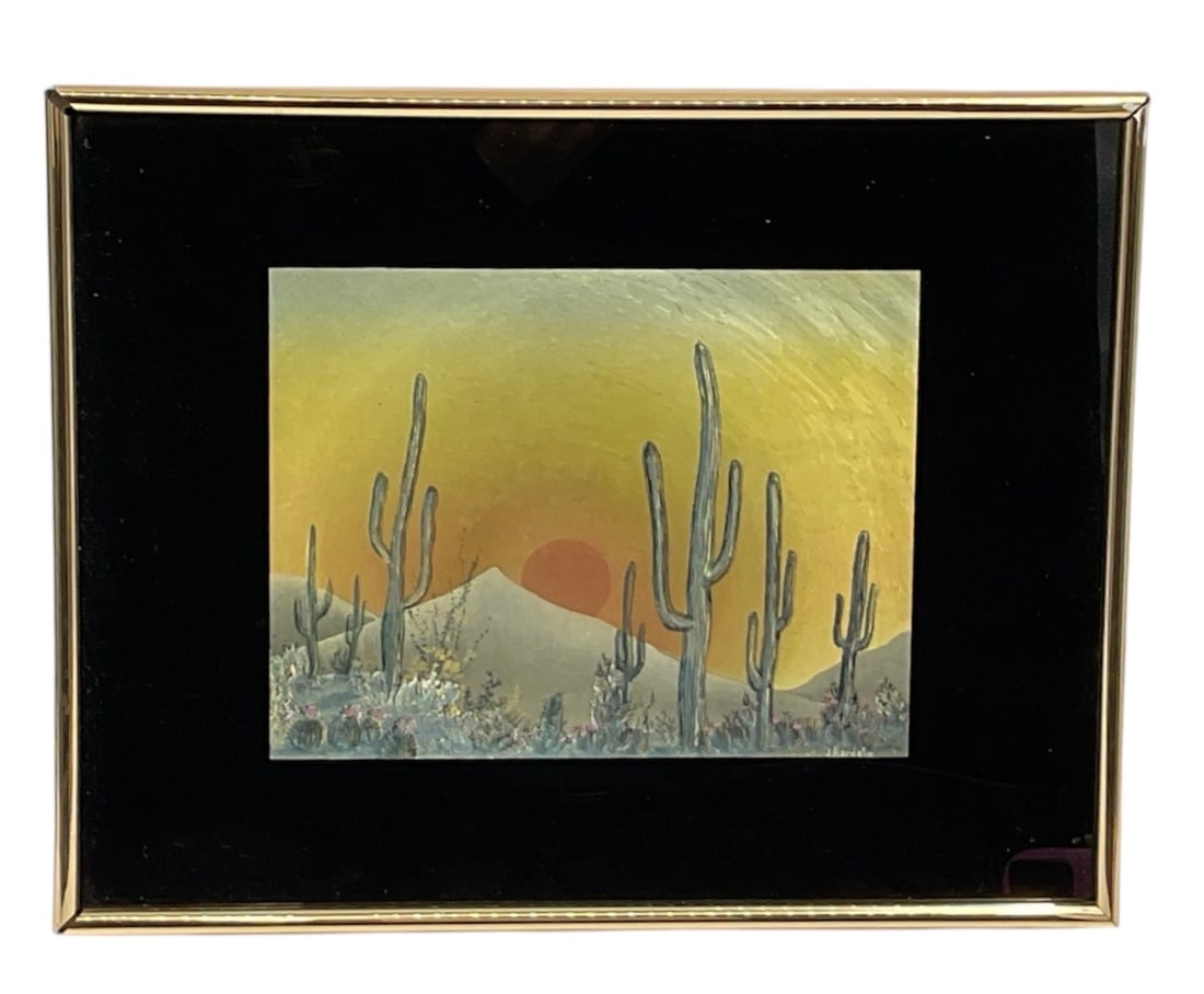 Framed Desert Landscape Painting by J. Hardelin: Framed desert landscape painting by J. Hardelin depicting a Southwestern scene with tall saguaro cacti set against distant mountains beneath a glowing sunset sky. Executed in soft atmospheric tones