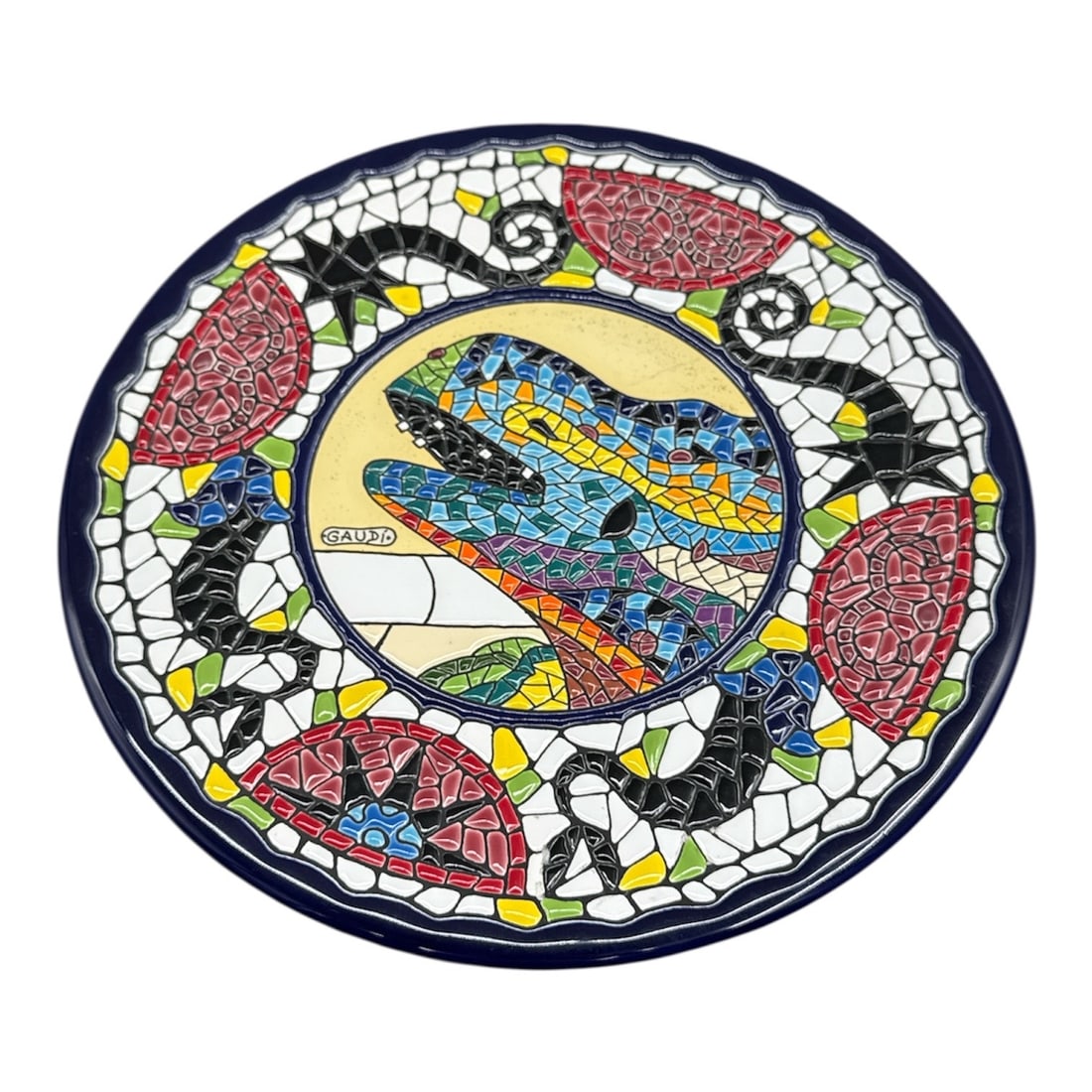 Coleccion Gaudi Made in Spain Mosaic Style Decorative Plate: Vibrant decorative plate from the Coleccion Gaudi series, inspired by the famous mosaic art style of Antoni Gaudi. This colorful piece features a striking reptile motif surrounded by bold mosaic patte