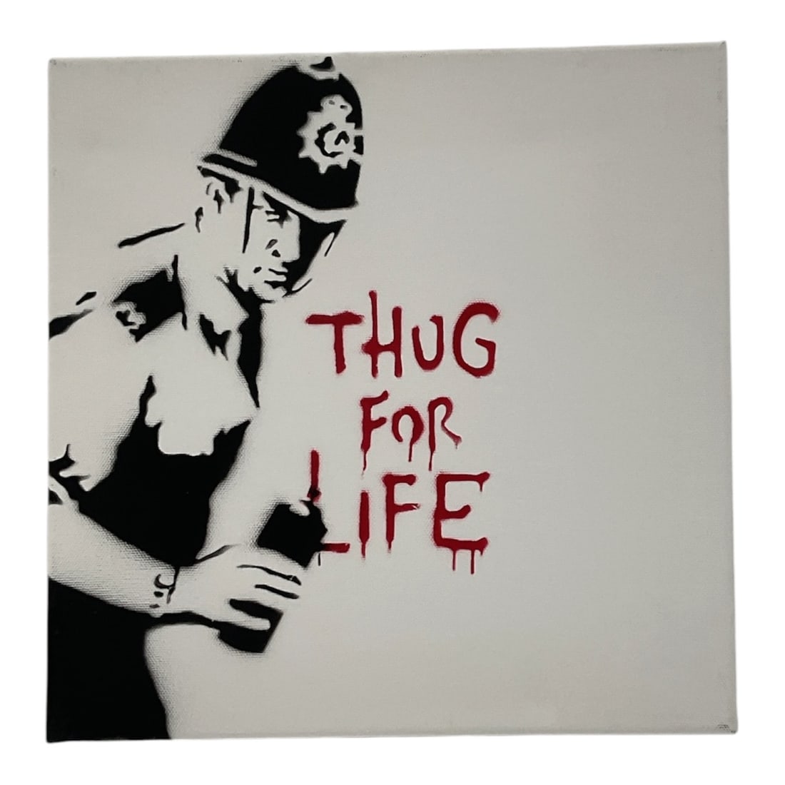 Banksy "Thug For Life" Spray Paint on Canvas: Original Banksy stencil artwork depicting a British police officer beside the graffiti phrase “Thug for Life” rendered in dripping red lettering. Executed in a monochrome spray paint