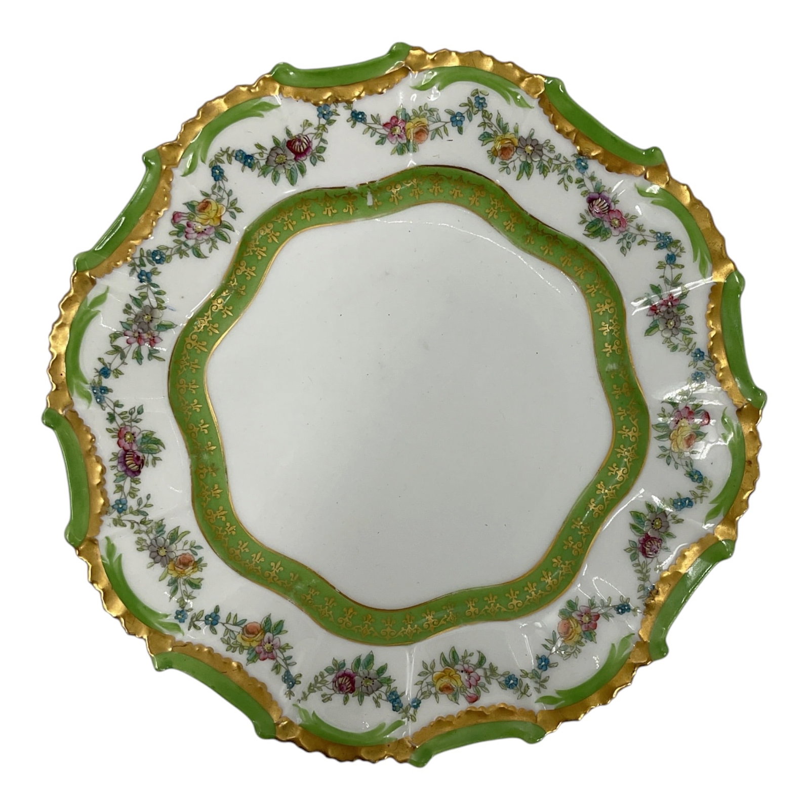 Abram French & Co.French Floral Cabinet Plate: Decorative French porcelain cabinet plate featuring an elegantly scalloped form with vibrant green border accents and extensive hand-applied gilt decoration along the rim. The center and border are