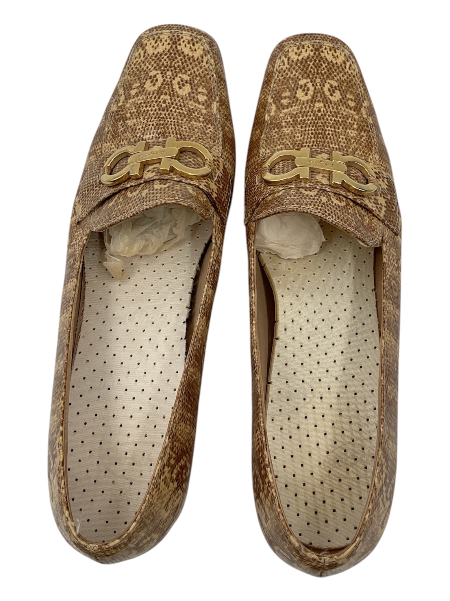 Salvatore Ferragamo Monogram Loafers: A pair of Salvatore Ferragamo loafers featuring an allover tonal monogram-style textile and leather upper accented with signature gold-tone Gancini hardware across the vamp. The shoes are designed in