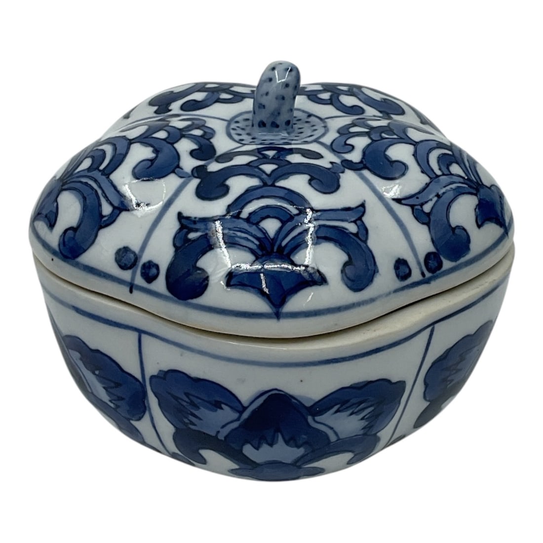 Blue and White Porcelain Covered Trinket Box: Decorative blue and white porcelain covered trinket box featuring scrolling floral and foliate motifs with matching domed lid and finial handle. Marked Made in China to underside. Attractive chinoiser