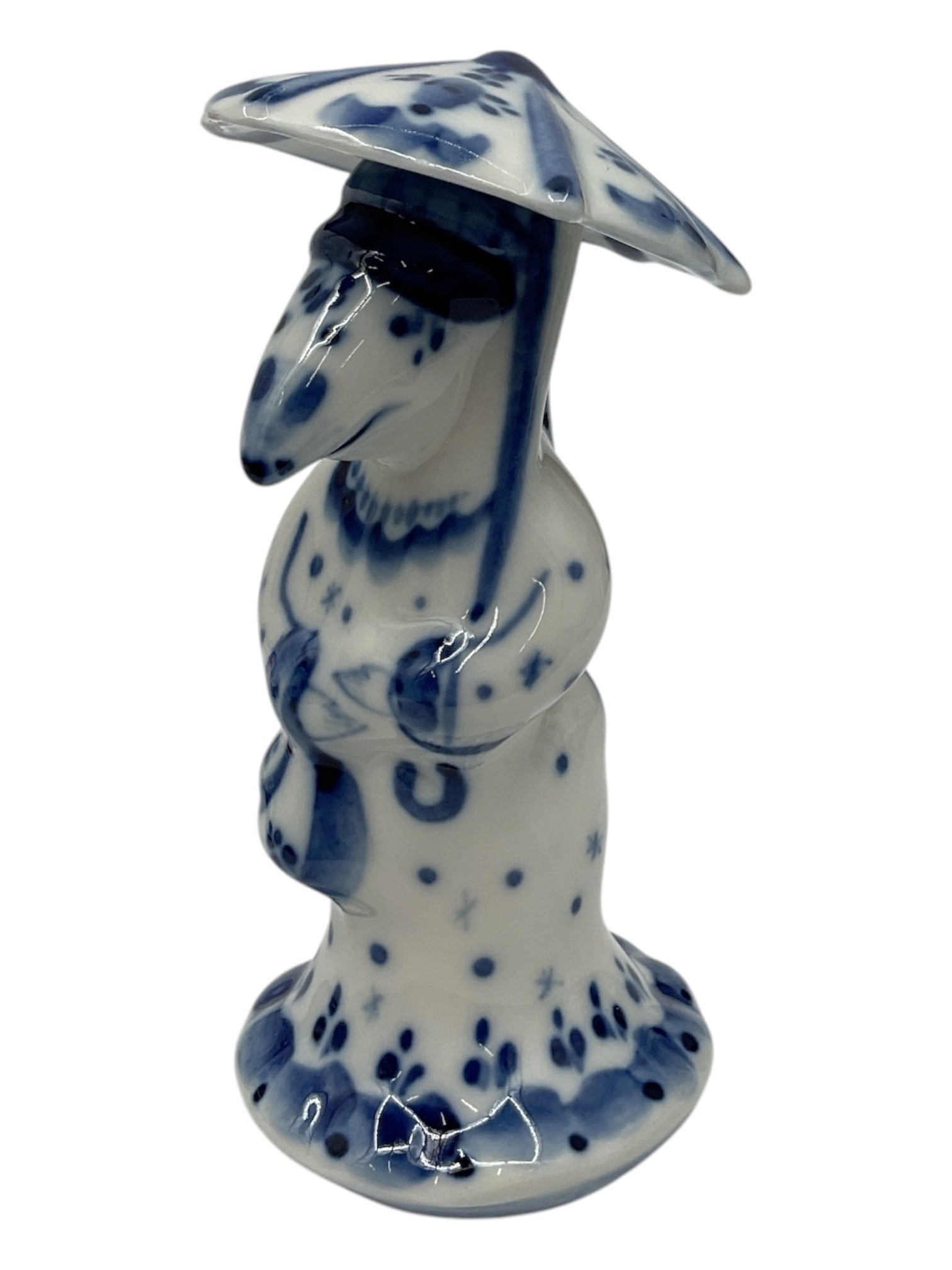 Delft Blue Porcelain Figurine of Asian Farmer: Blue and white Delft-style porcelain figurine depicting a standing farmer or traveler wearing a broad hat and traditional robe. Hand painted decoration throughout with maker’s mark to underside.