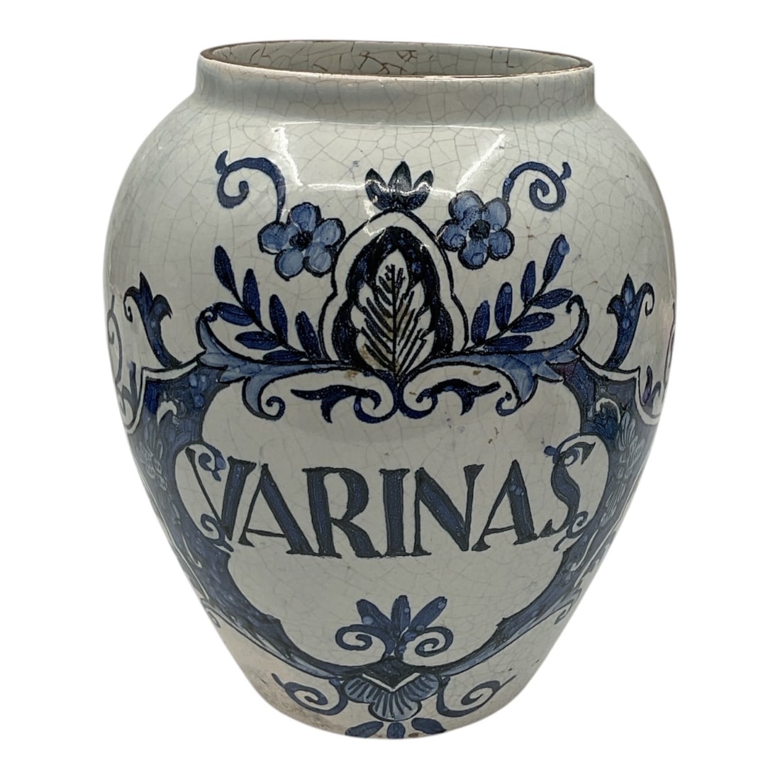 Blue and White Pottery Apothecary Jar Marked Varinas: Decorative pottery apothecary jar featuring blue and white floral and scrolling decoration with central cartouche marked Varinas. Rounded baluster form with crackle glaze finish and hand painted detai