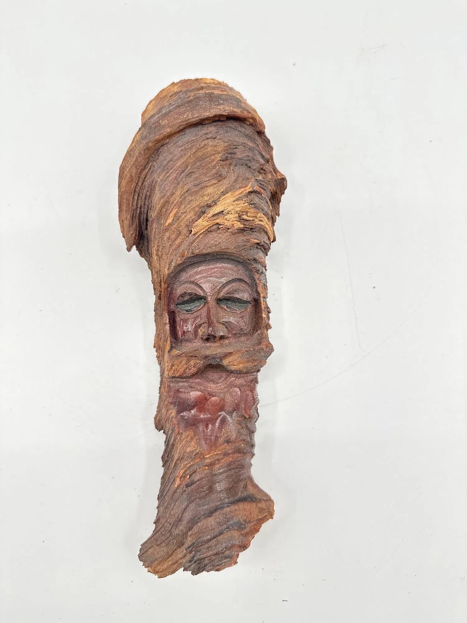 Rustic Tree Bark Face Carving: A hand-carved face sculpture crafted from natural tree bark, depicting a bearded man with a tall headdress or turban. The natural contours of the bark are integrated into the figure’s flowing be
