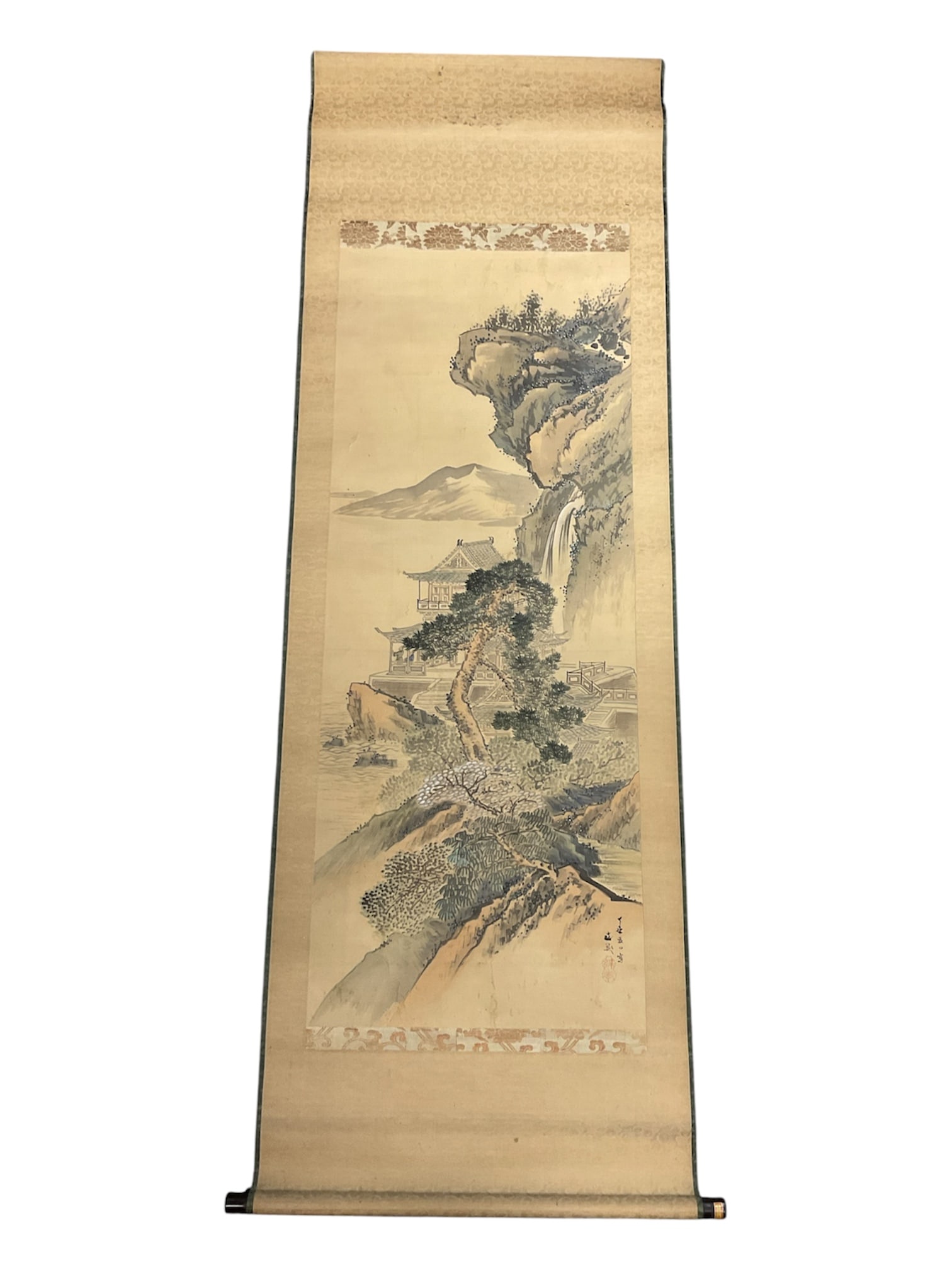 Japanese Landscape Hanging Scroll (Kakejiku), Signed: Traditional Japanese hanging scroll (kakejiku) depicting a serene mountainous landscape with temple architecture, cascading waterfall, pine trees, and distant shoreline rendered in delicate ink and mu