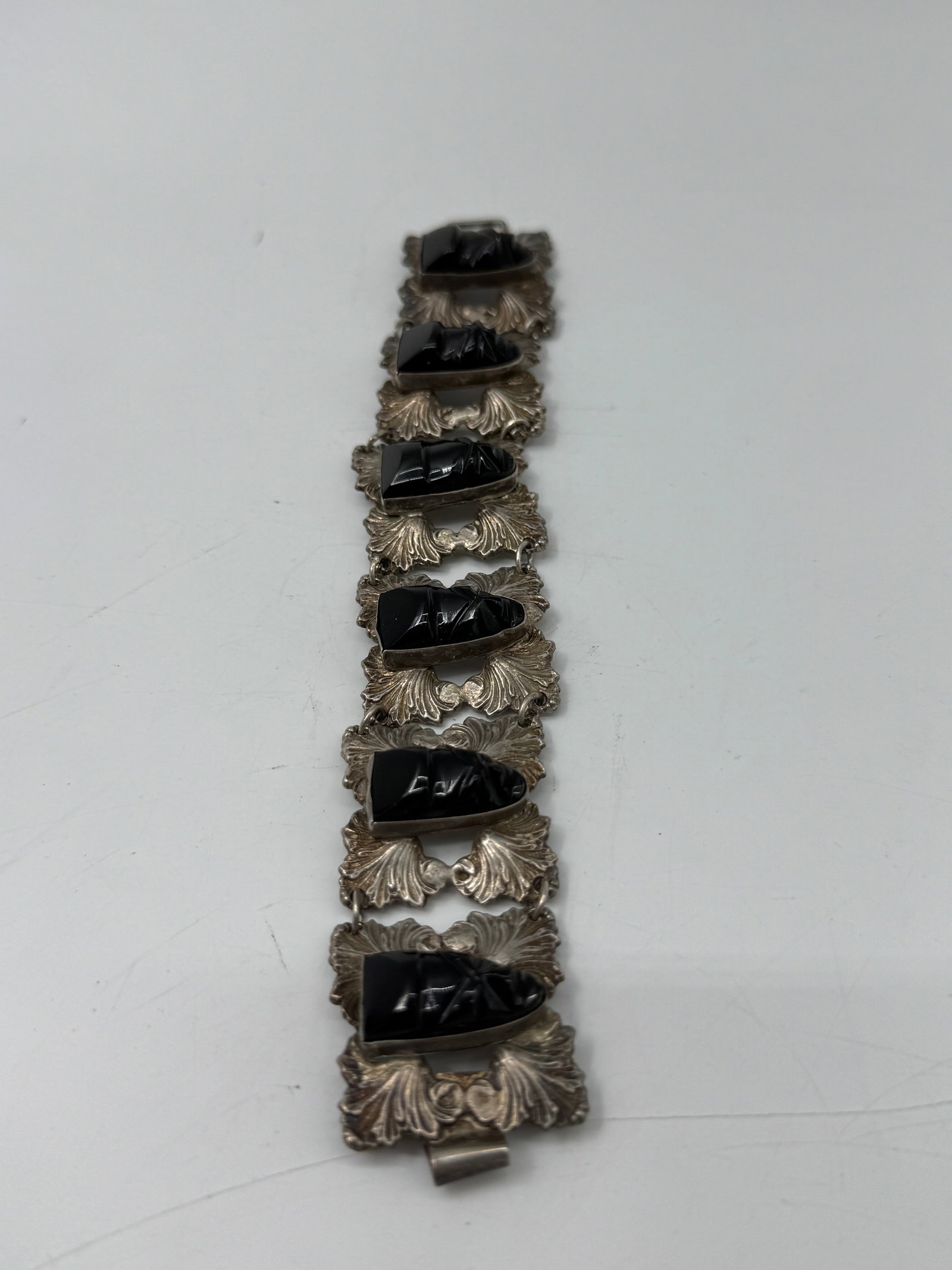 Vintage Mexican Sterling Silver Bracelet with Carved Stone Heads: Marked "Rubens Silver Mexico", featuring six panels with abstract carved stone motifs (possibly iolite, tourmaline, or onyx). Weight 64g 6in long