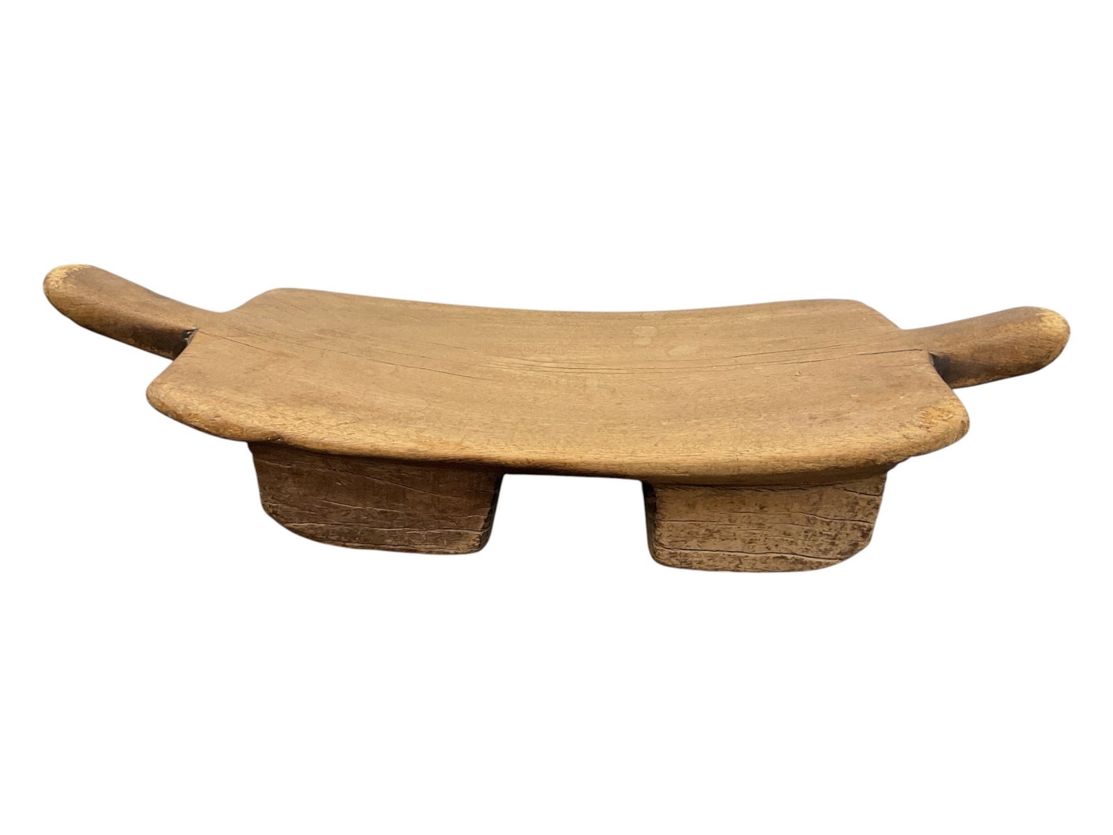 Hand-Carved African Wooden Neck Rest / Low Stool: This traditional African tribal neck rest or low stool is hand-carved from a single piece of light-toned hardwood, exhibiting an authentic, aged patina with natural splitting and wear consistent with 