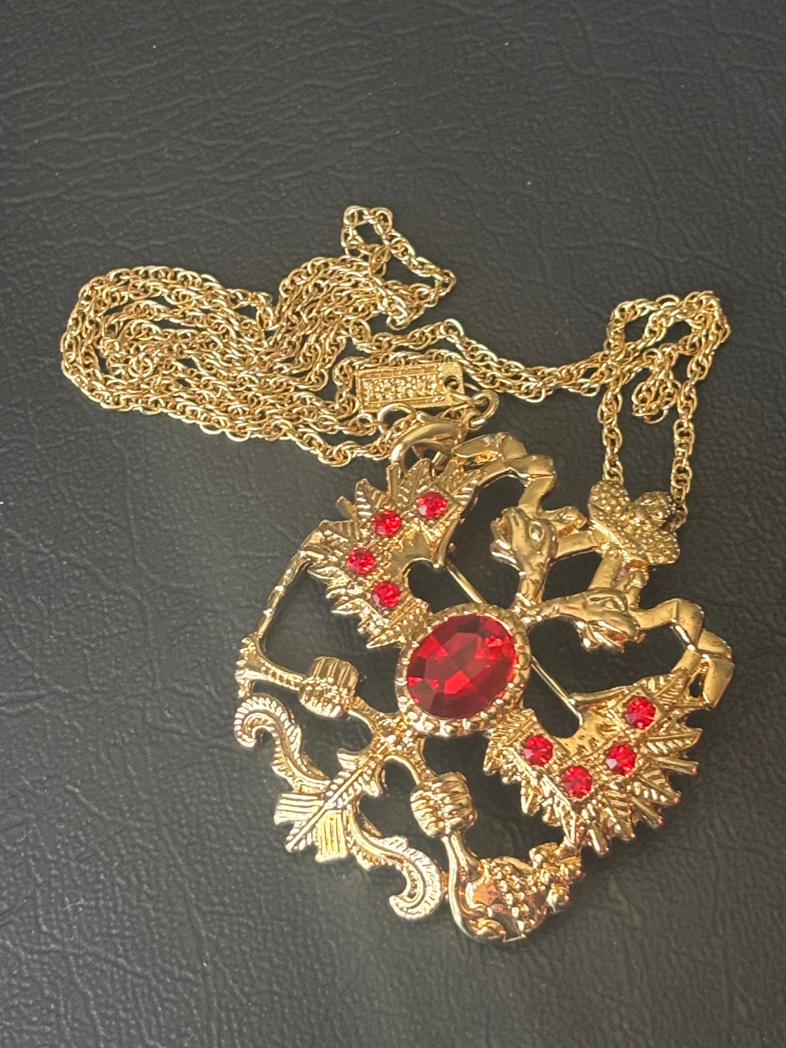 Fabergé Imperial Romanov Double-Headed Eagle Pendant/Brooch: A striking contemporary Fabergé costume jewelry convertible pin/pendant necklace, celebrating historic Russian imperial heraldry. Crafted in a polished gold-tone base metal, the openwork design