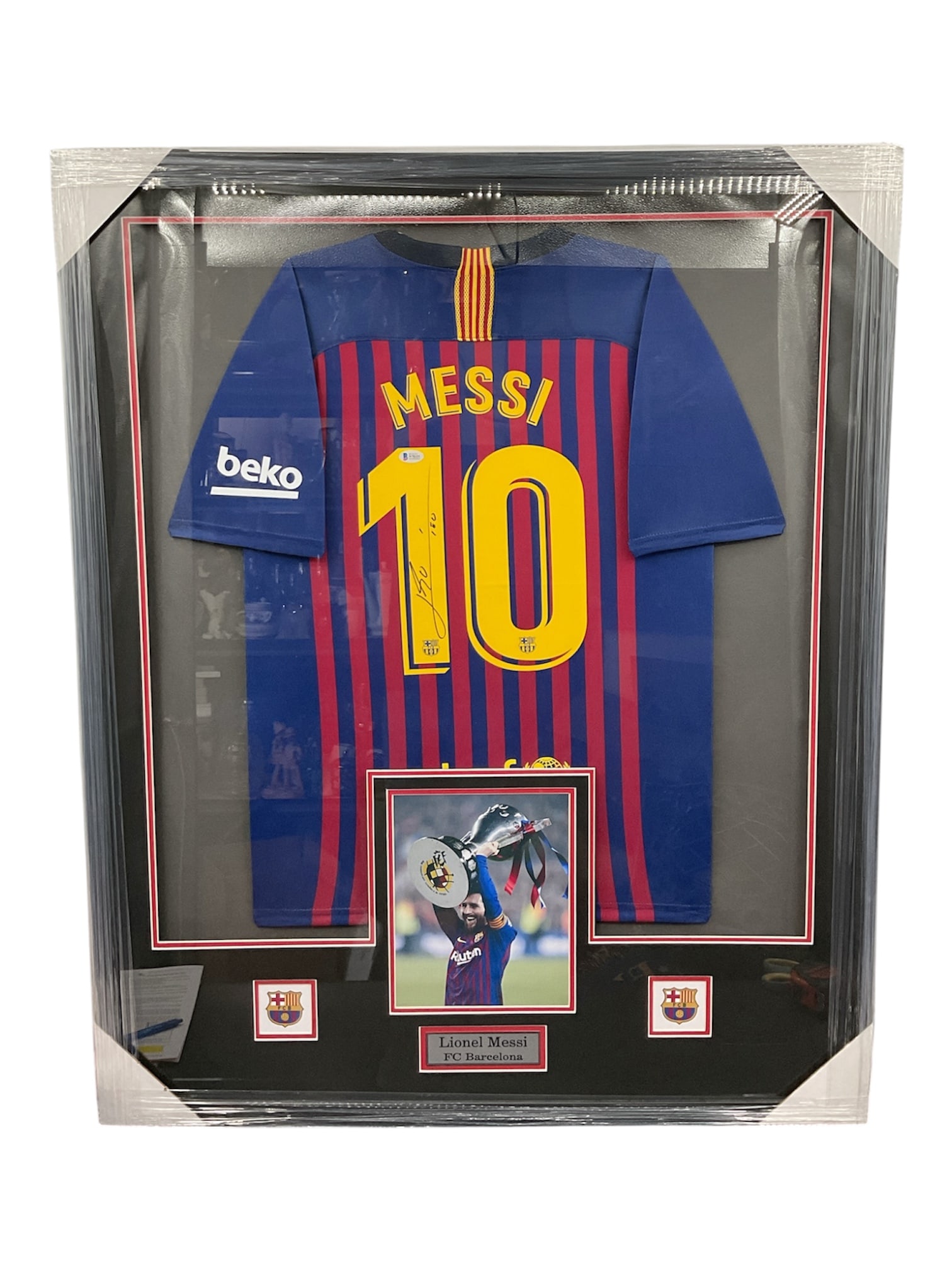 Lionel Messi Signed FC Barcelona No. 10 Jersey, Framed Display: Framed display featuring an FC Barcelona home jersey bearing the name “Messi” and number 10, associated with legendary footballer Lionel Messi. The jersey is presented in the club’s 