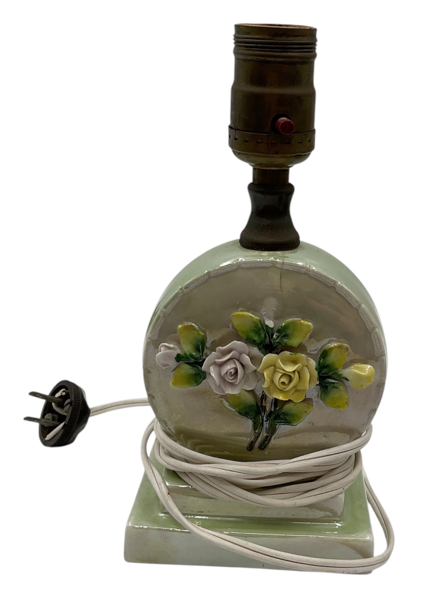 Vintage Floral Porcelain Boudoir Lamp: Vintage porcelain boudoir lamp featuring a rounded globe-form body decorated with applied and hand-painted roses in relief. The lamp is finished in soft green tones and mounted on a matching square po