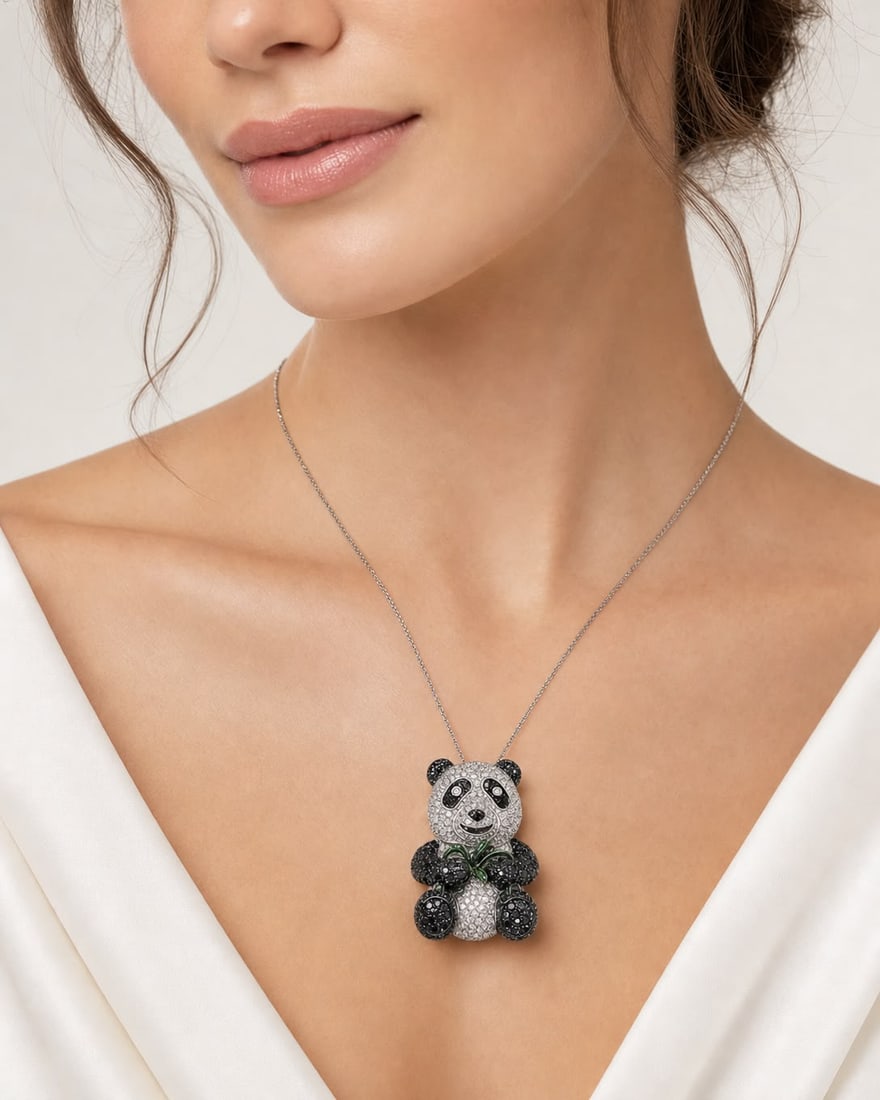 Black and White Diamond Panda Brooch Pendant Necklace: A whimsical and luxurious panda-form brooch pendant adorned with black and white pavé-set stones throughout. The seated panda holds green stone bamboo accents, with contrasting dark and bright 