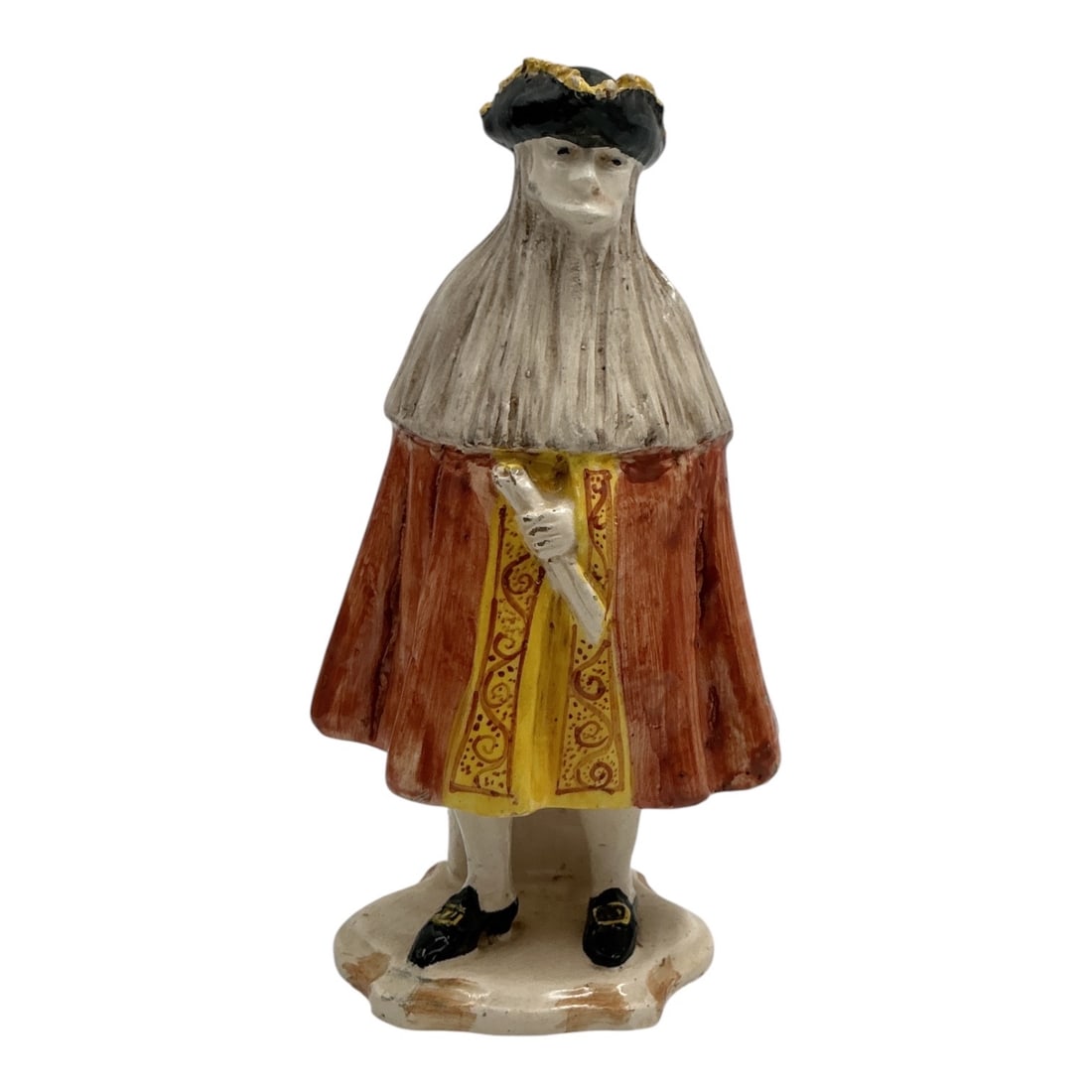 German Ceramic Figural Sculpture of a Gentleman in Period Dress: German ceramic figural sculpture depicting a gentleman in historical European attire, wearing a broad-brimmed hat, long cape, decorative tunic, and carrying a scroll. Hand-painted in muted earth tones