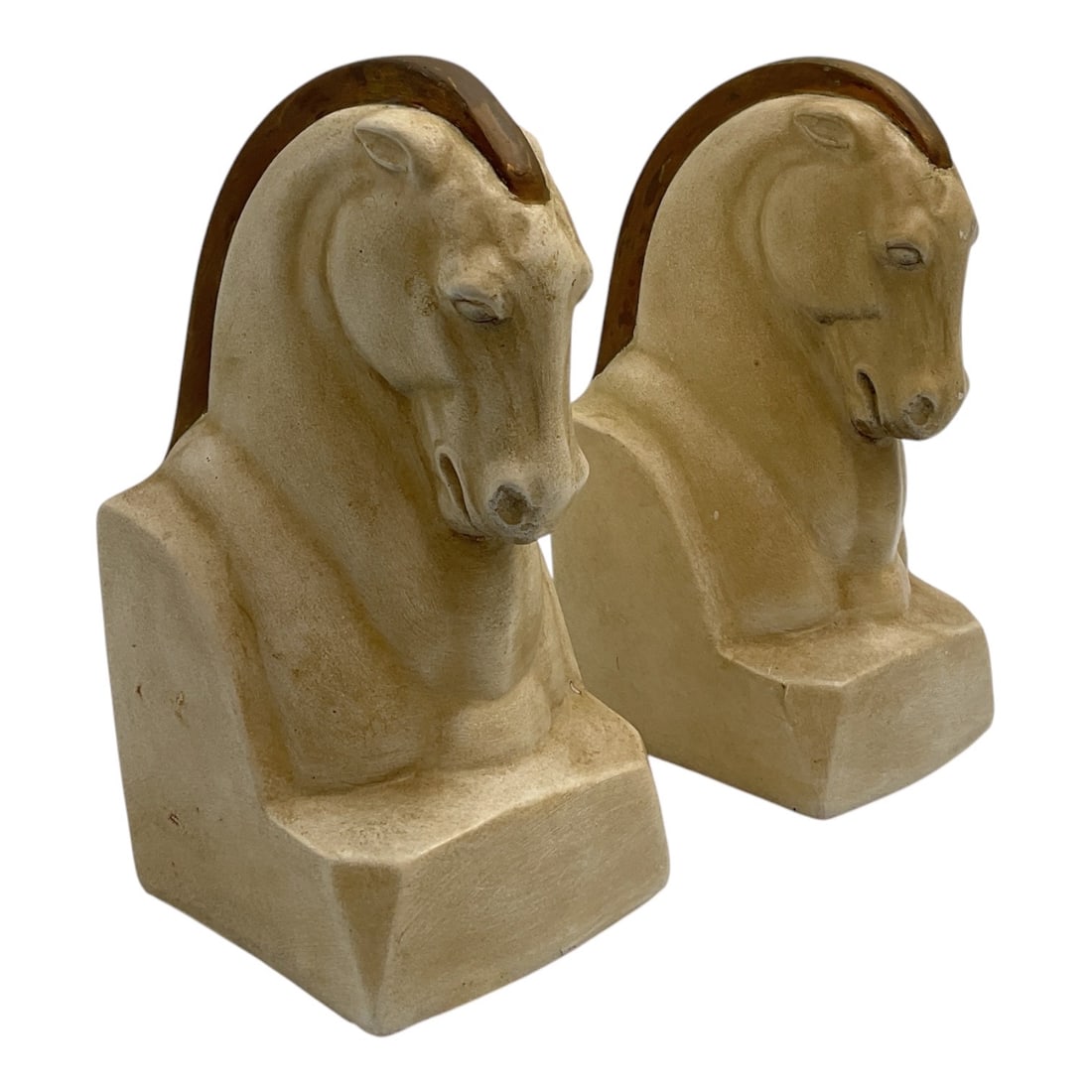 Pair of Carved Horse Head Bookends: Pair of carved horse head bookends featuring stylized equine busts mounted on rectangular bases with curved wood backings. Executed in a natural stone or composite stone material with a warm buff-colo