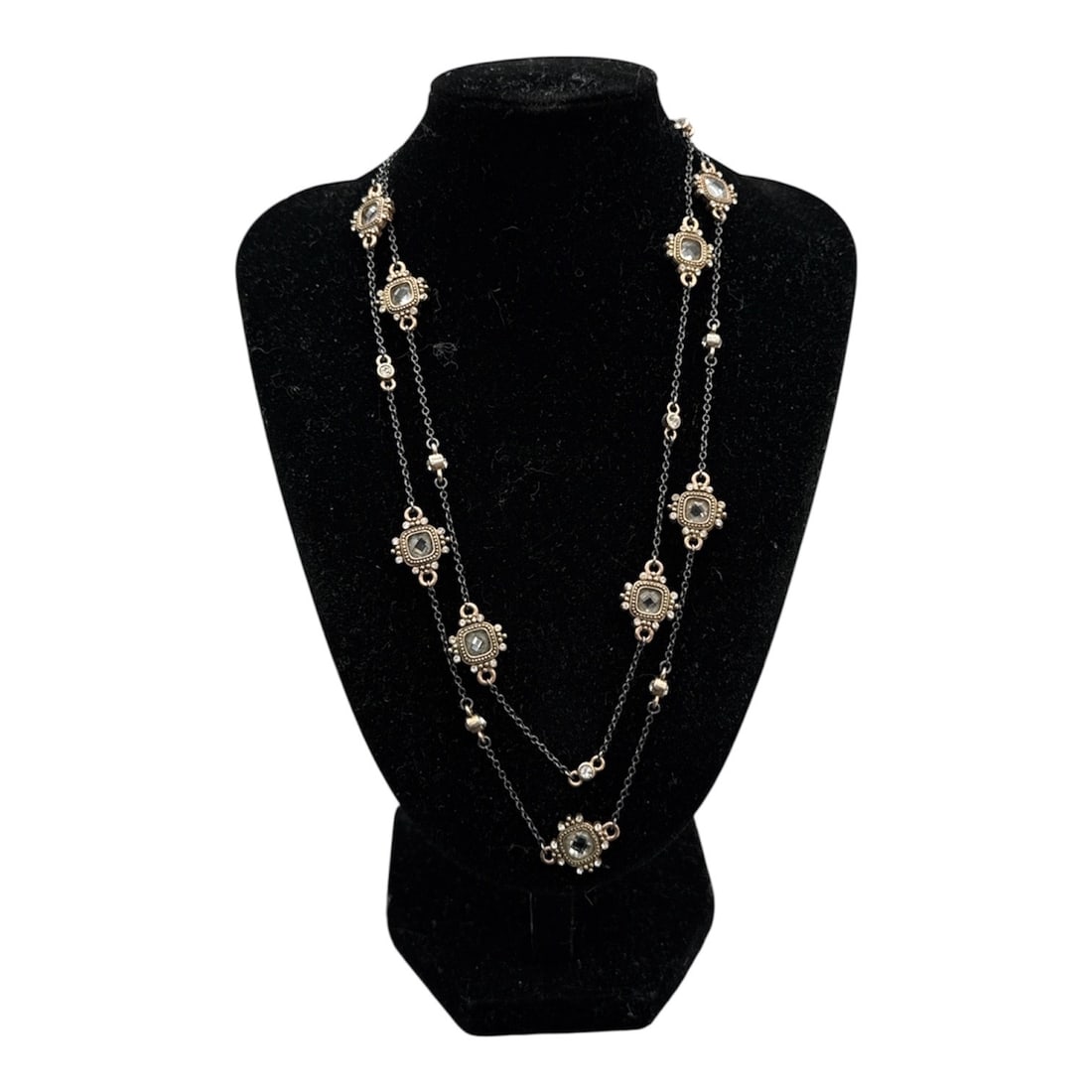 Long, Double-Strand Station Necklace: Long, double-strand station necklace featuring ornate floral or sunburst medallions.