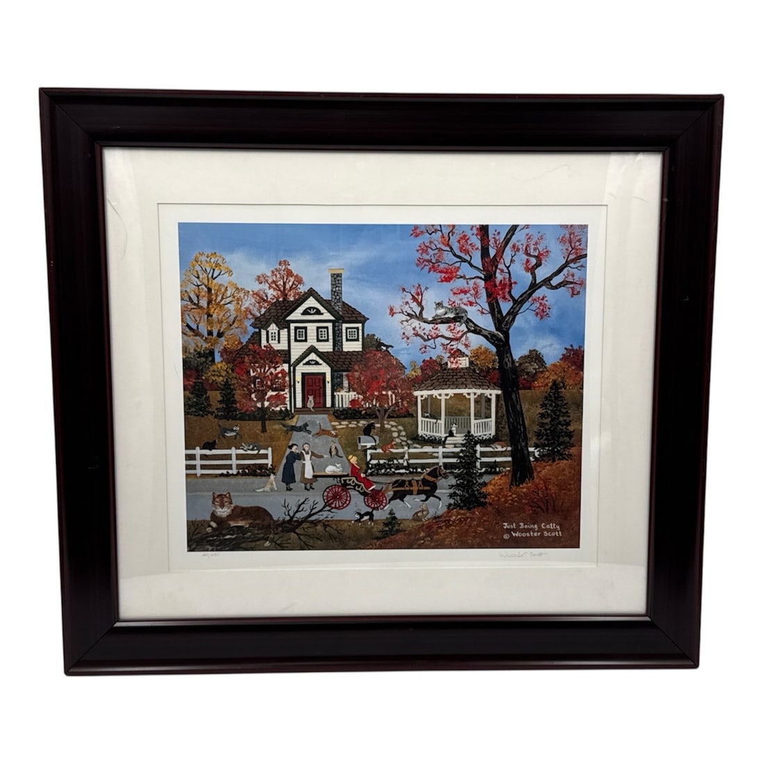 Jane Wooster Scott Just Being Catty Limited Edition Lithograph Framed 321/495: Limited edition lithograph on paper titled Just Being Catty by American folk artist Jane Wooster Scott. This charming autumn scene depicts a lively countryside home surrounded by vibrant fall foliage,