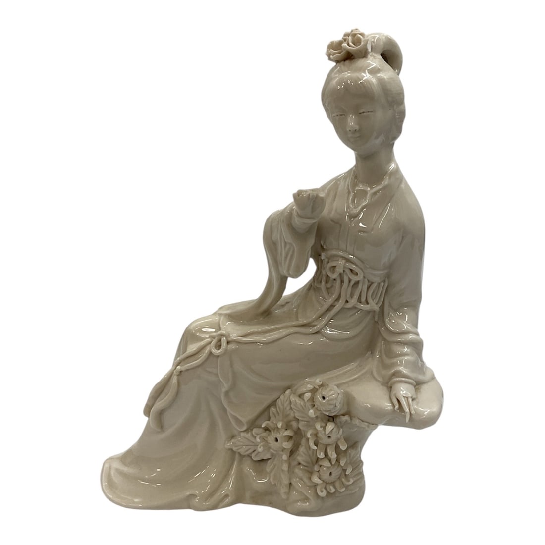 Vintage Blanc de Chine Style Seated Chinese Porcelain Figurine: This vintage Chinese figurine is crafted from white bisque porcelain in the Blanc de Chine style, depicting a seated female figure in traditional dress. The sculpture features flowing robes, delicate 