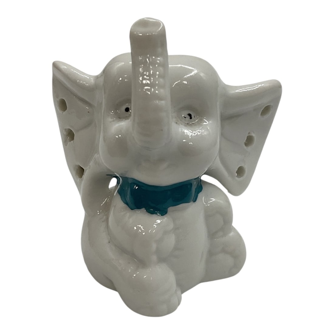 Vintage White Ceramic Elephant Jewelry Holder: This vintage white ceramic elephant jewelry holder features a charming design accented by a bright blue bow. The elephant's pierced ears are designed to hold multiple pairs of earrings, while its 