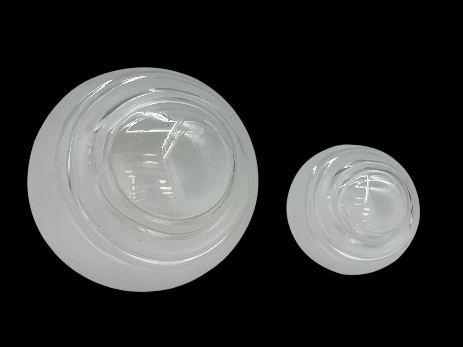 Pair of Modern Frosted Glass Orb Vases: A pair of modern frosted glass orb vases featuring smooth rounded bodies with small circular openings at the top. The minimalist spherical forms create a soft sculptural presence, suitable for single 
