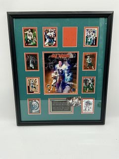 Dan Marino Framed Display with Trading Cards and Autograph with C.O.A.: Framed display featuring Dan Marino memorabilia. Includes trading cards and a central image with an autograph. Dimensions: H26.5 x L22 inches. Certificate of Authenticity on verso.