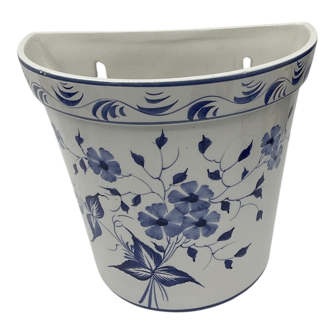 Blue and White Floral Wall Pocket Planter - Portugal: Decorative ceramic wall pocket planter featuring blue floral decoration with scrolling border accents along the rim. Tapered form with flat back and mounting openings for wall display. Marked Pottery 