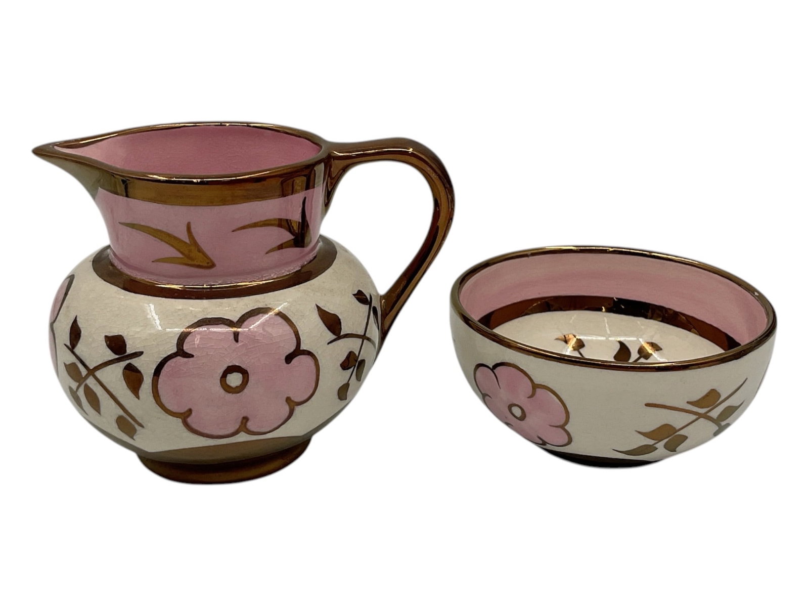 Pair of Sandland Ware Lustre Decorated Creamer and Bowl: Decorative pair of Sandland Ware ceramics including a handled creamer pitcher and matching bowl. Each features pink floral decoration with copper lustre accents on a cream ground. Marked Sandland Ware