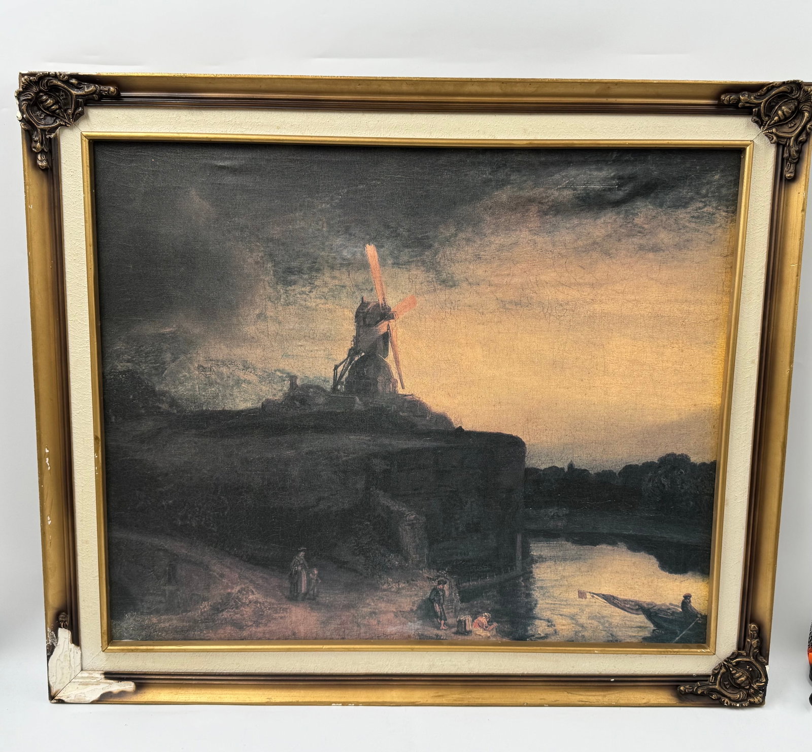 "The Mill" After Rembrandt van Rijn: Description: Oil on canvas painting, after Rembrandt's 'The Windmill'. Depicts a windmill atop a hill overlooking a river landscape. Framed. Medium: Oil on canvas Dimensions: